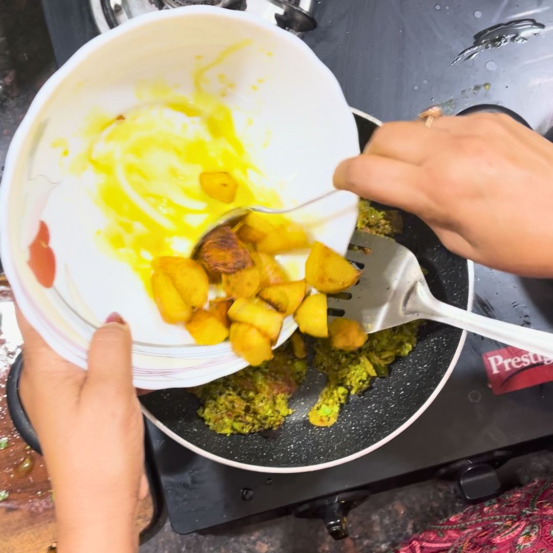 Image of Add the grated boiled potatoes to the pan. Mix thoroughly...