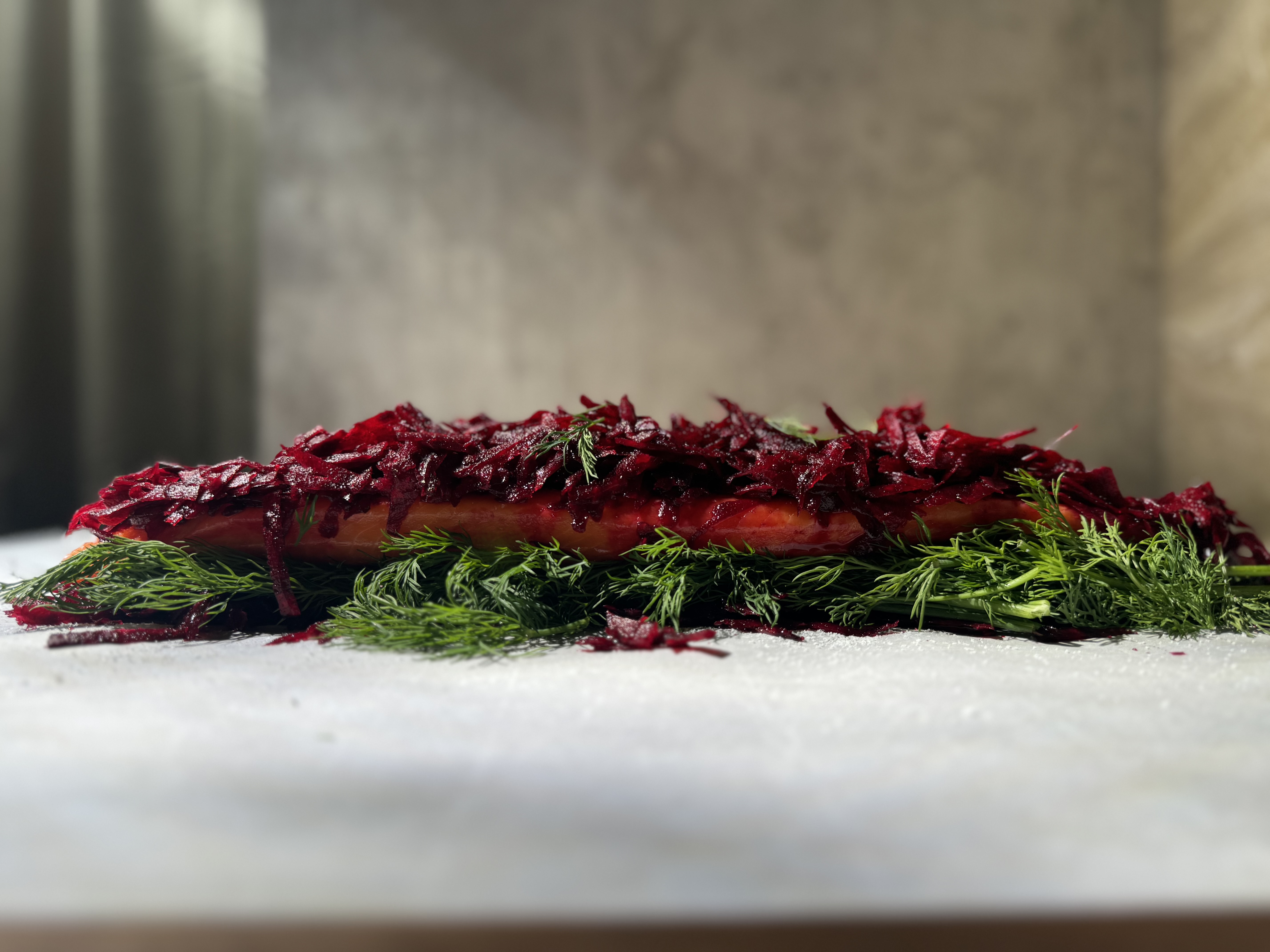 Image of Create the Curing Layer: Spread half of the beet-gin mixture...