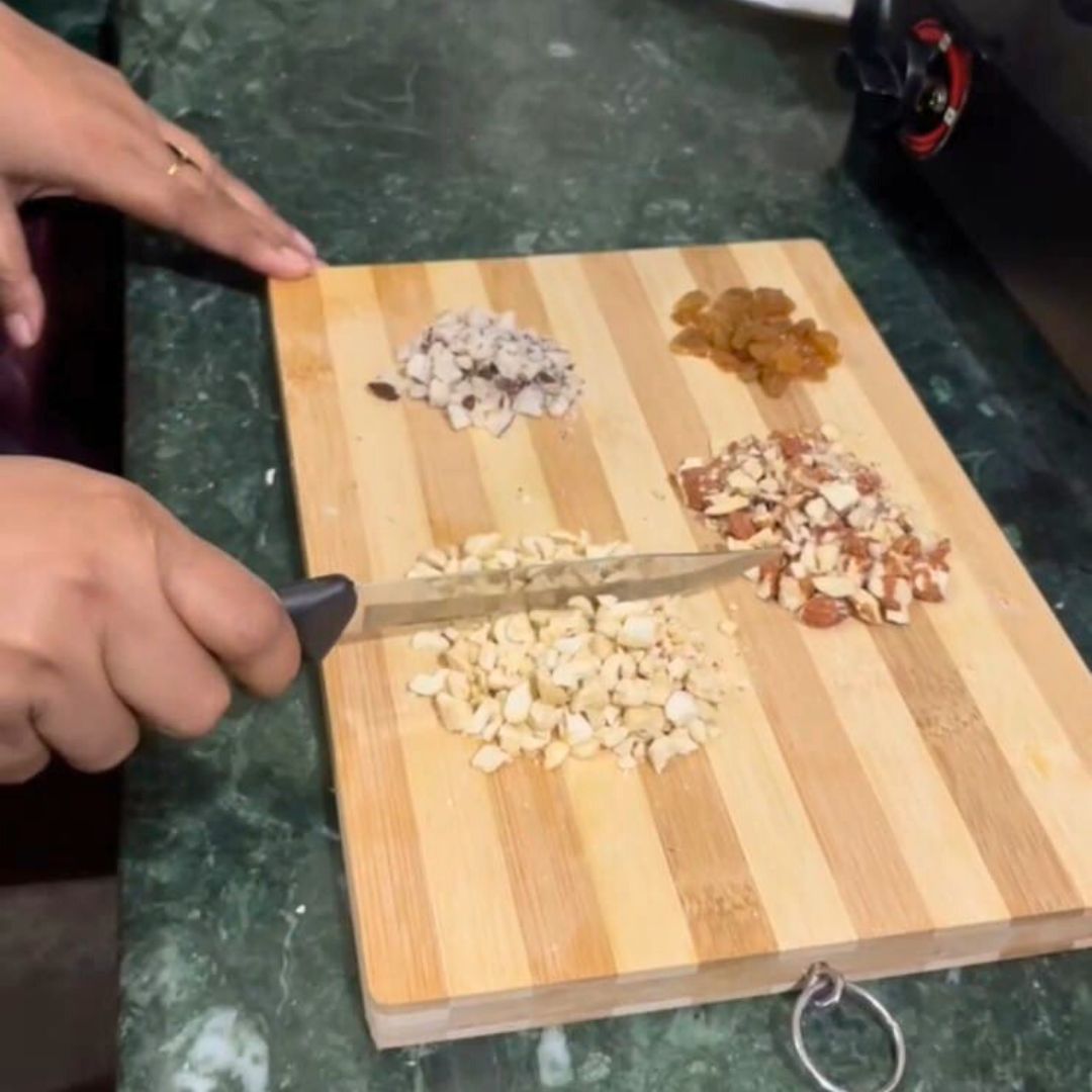 Image of Chop the dry fruits (cashews, almonds, raisins, dates) into small...