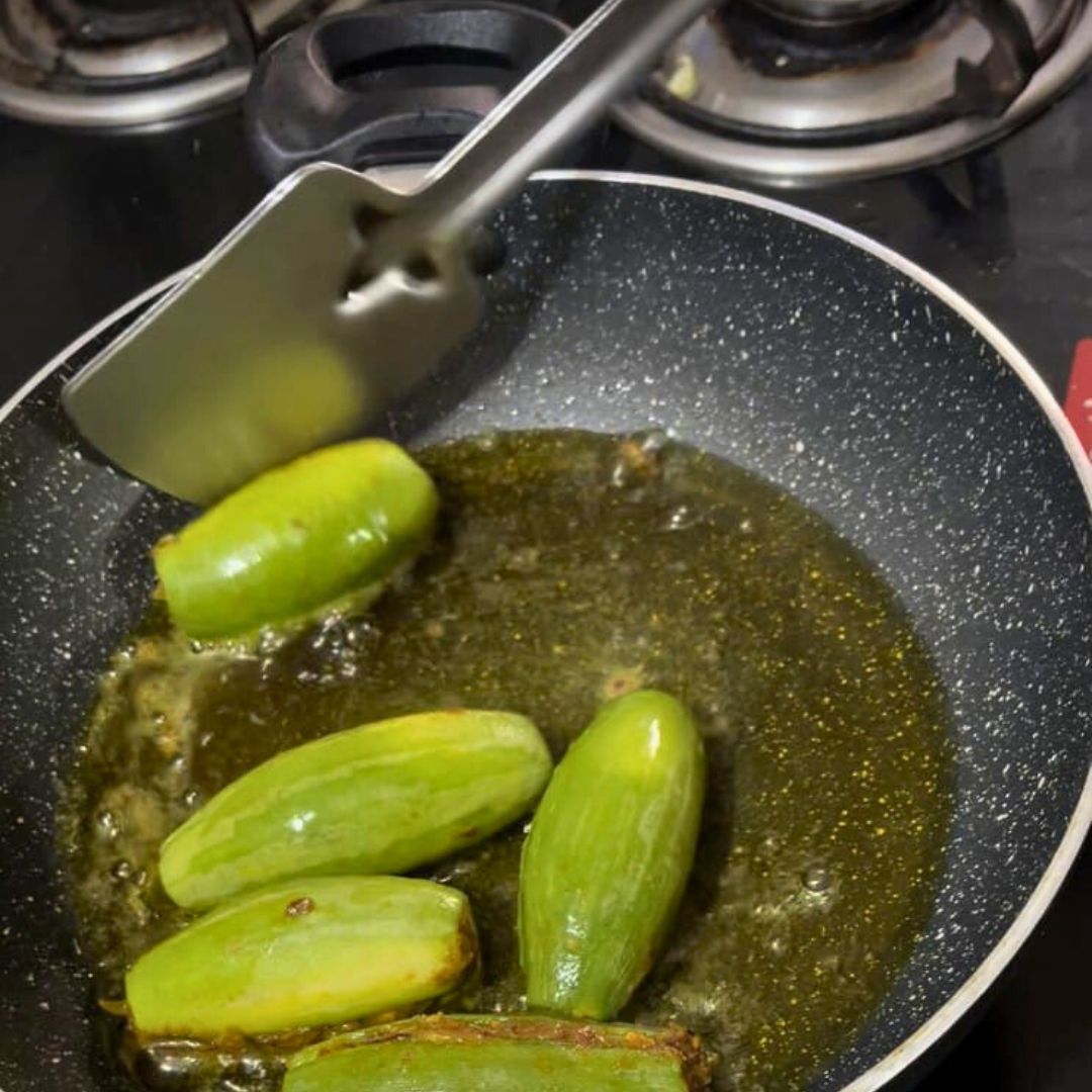 Image of Cook on low heat, turning occasionally, so the parwal cooks...