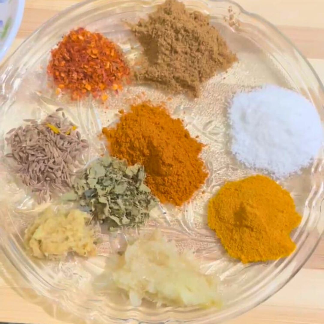 Image of Add turmeric powder, red chili powder, and coriander powder and...