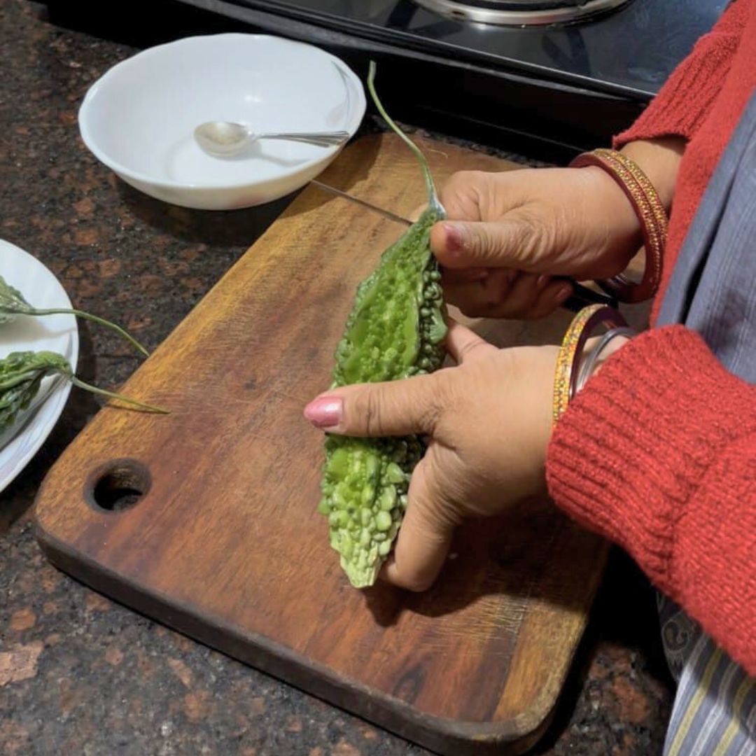 Image of Wash the karela thoroughly and trim the ends.