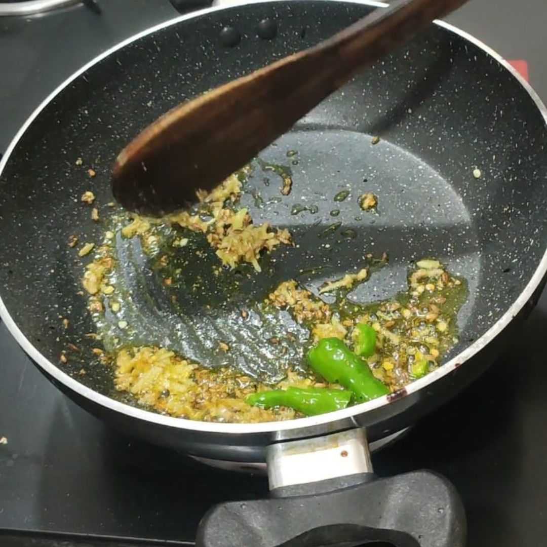 Image of Add grated ginger and green chili. Sauté for 1-2 minutes.