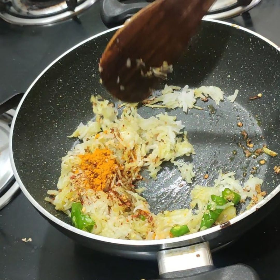 Image of Add the squeezed radish, carom seeds, and coriander powder. Cook...