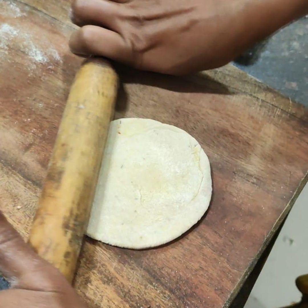 Image of Roll it out again into a paratha, ensuring the stuffing...