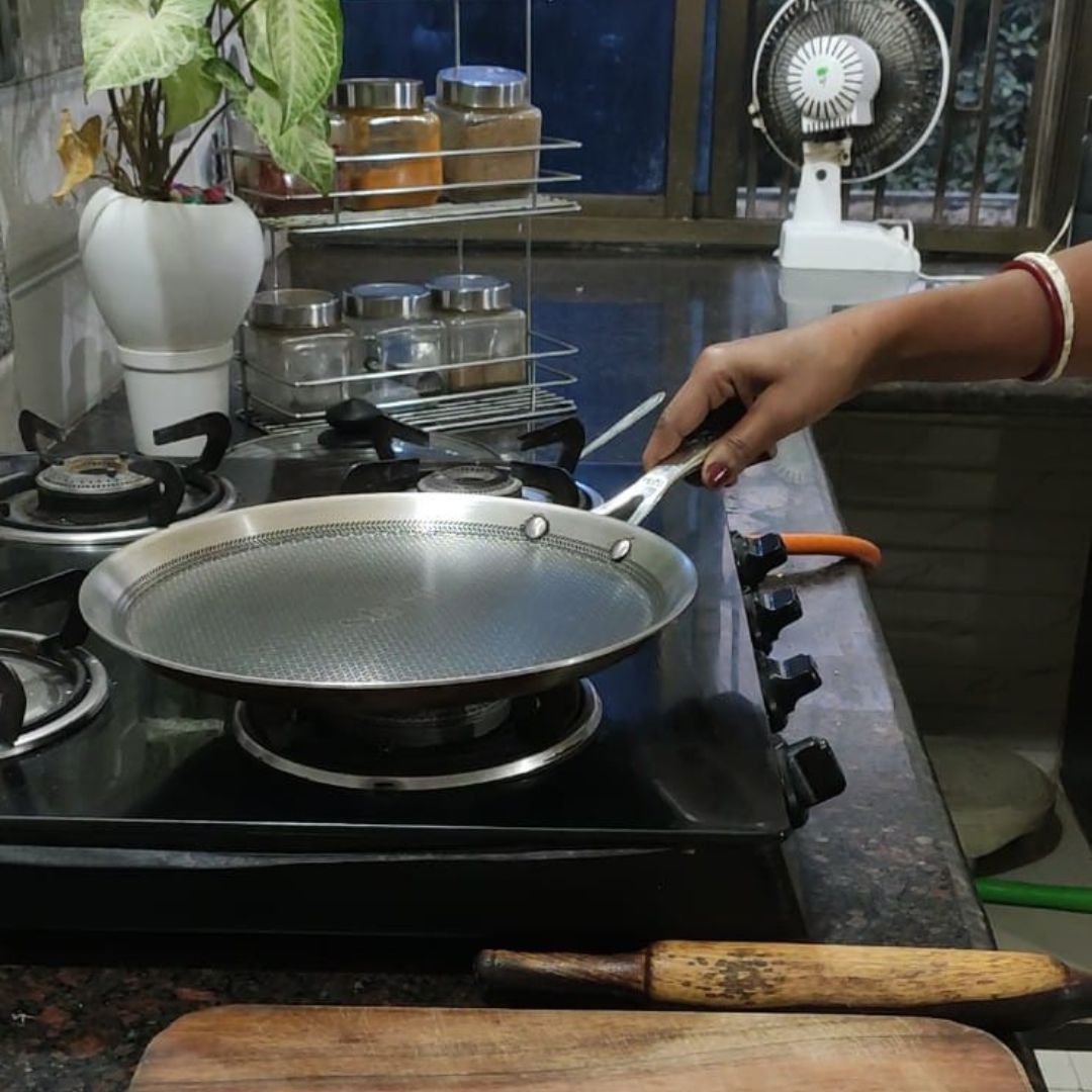 Image of Heat a tawa or griddle over medium flame.