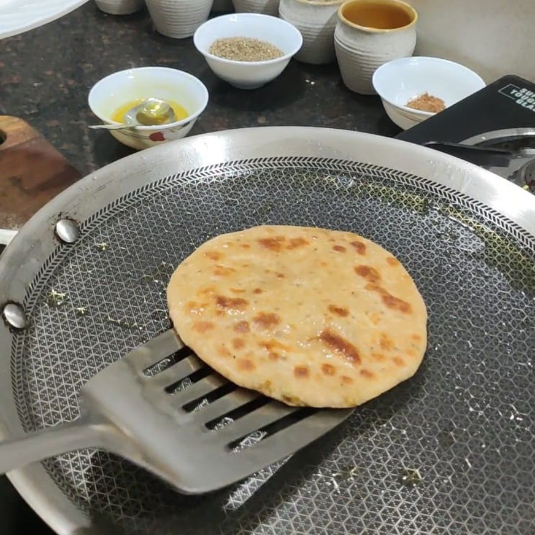 Image of Place the rolled-out paratha on the hot tawa and cook...