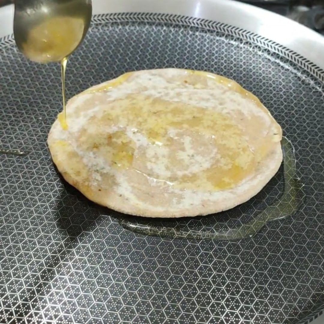 Image of Flip the paratha and apply oil or ghee. Cook until...