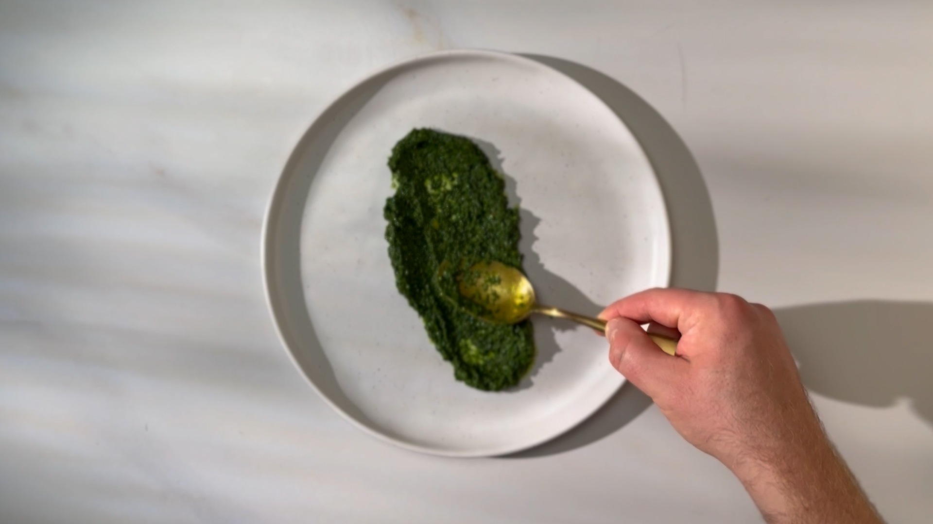 Image of Create the Pesto Bed: Spread the parsley-spinach pesto evenly across...