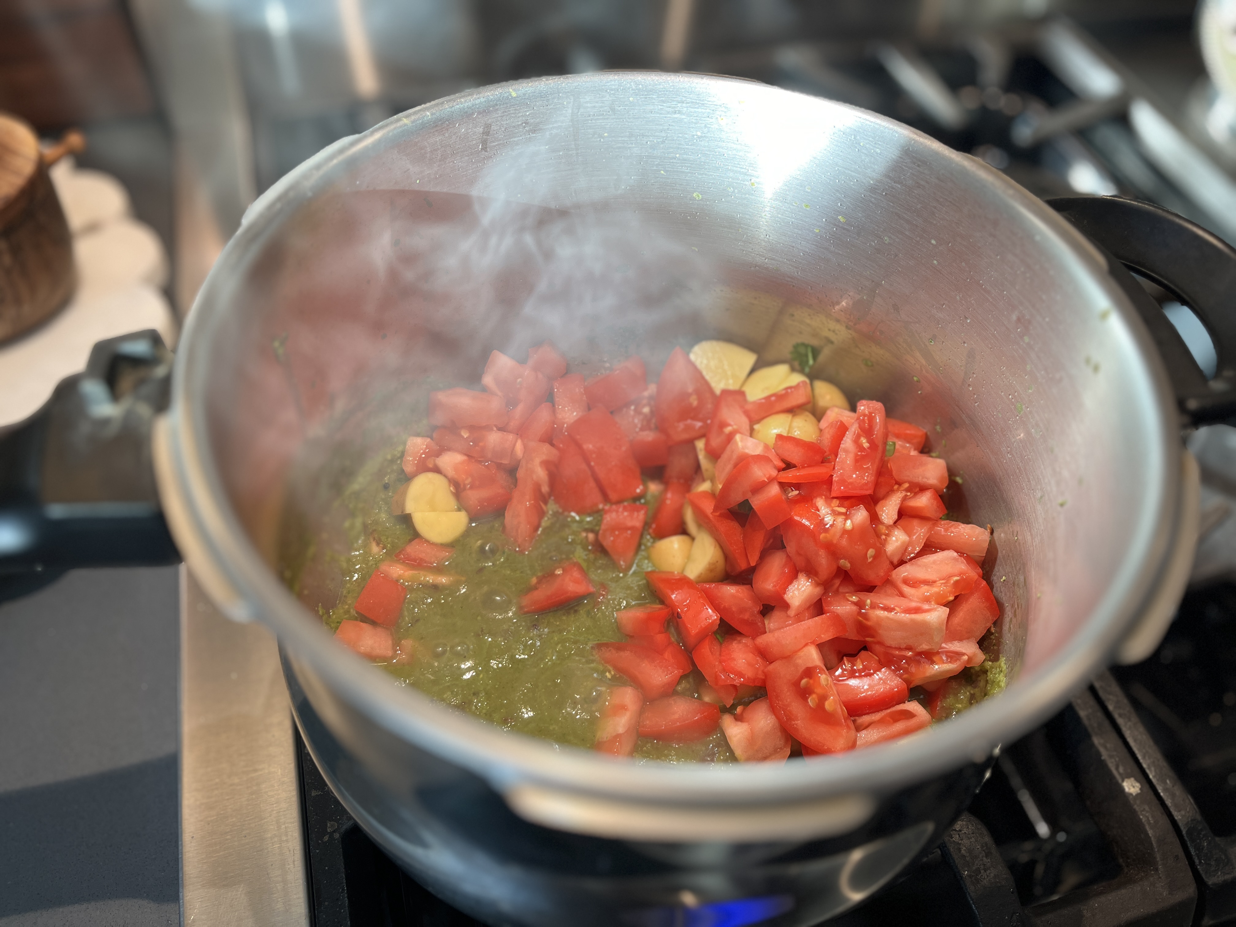 Image of Add the chopped tomato and potatoes and cook until the...