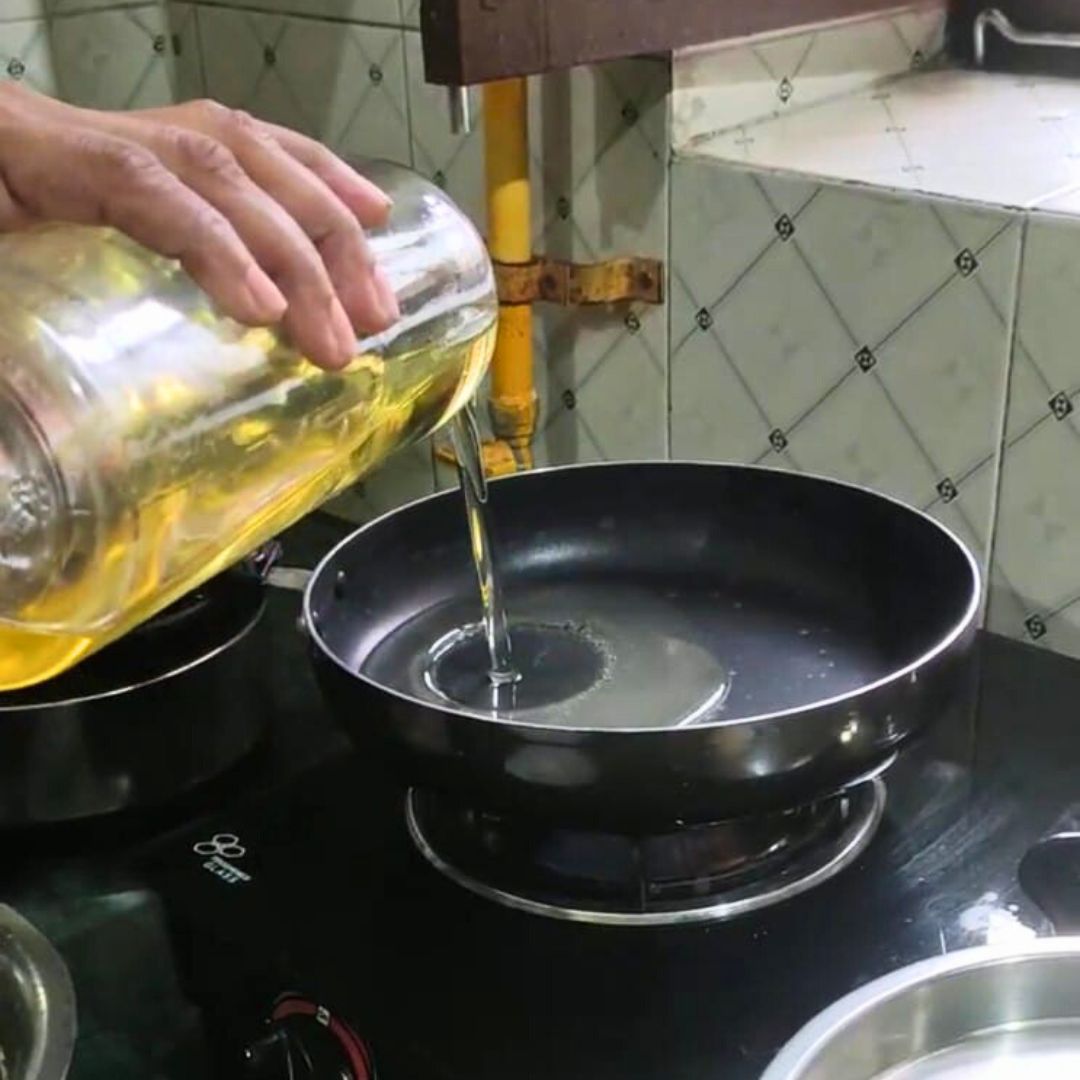 Image of Heat oil in a deep frying pan over medium flame.