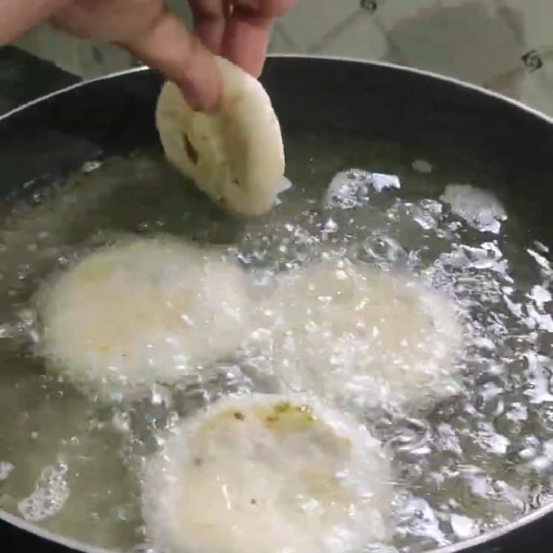 Image of Carefully slide the kachoris into the hot oil