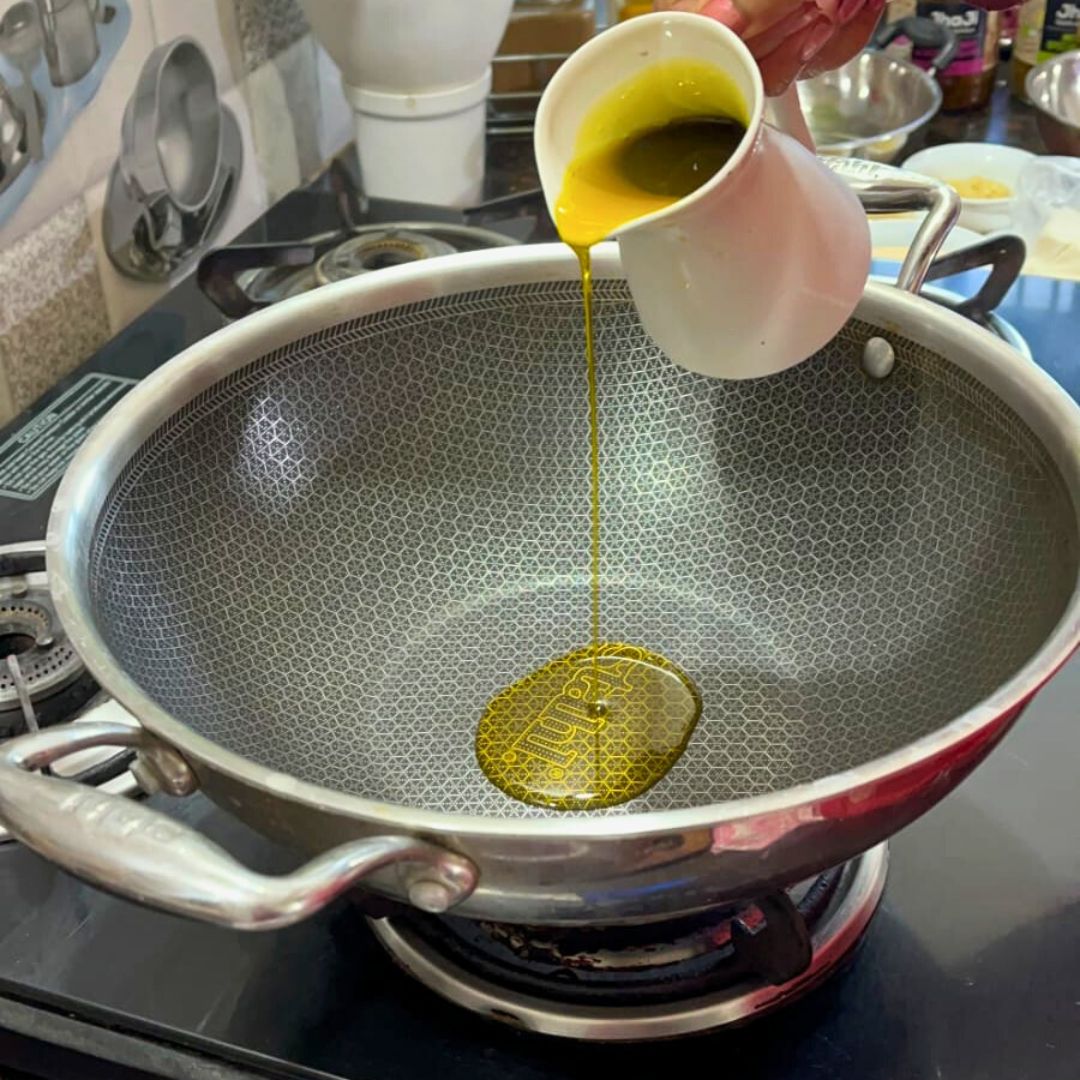 Image of Heat ghee or oil in a pan over medium flame.