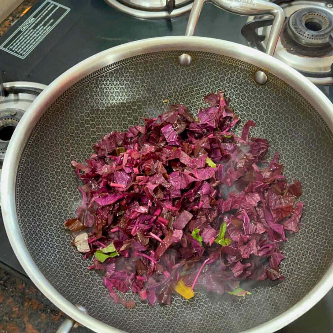 Image of Add the chopped red saag to the pan and mix...