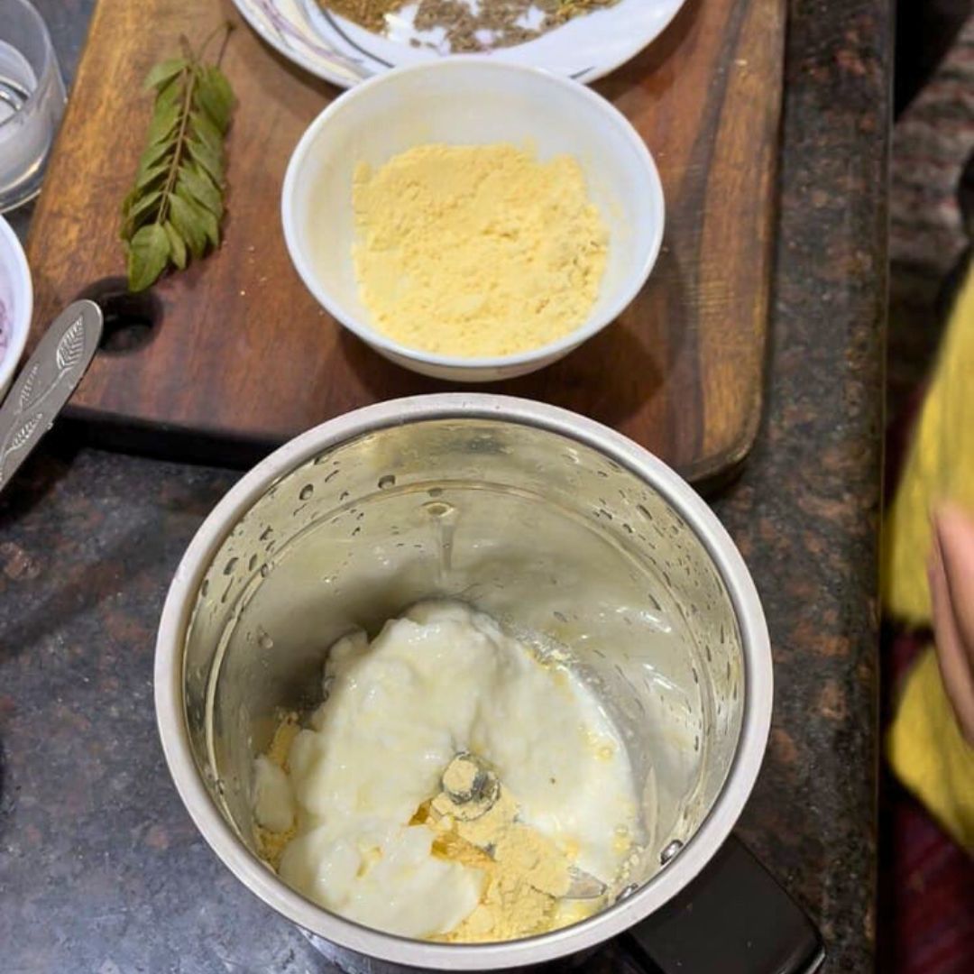 Image of In a large mixer, combine gram flour, yogurt, and water.