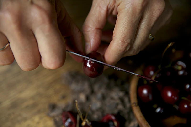 Image of Cut the cherries in half.