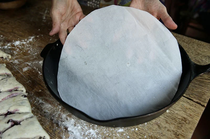 Image of Place parchment paper in the bottom of the skillet.