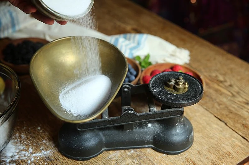 Image of Measure and add the sugar.