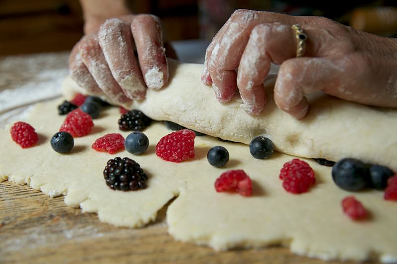 Image of Finish rolling the entire dough making sure the fruit is...