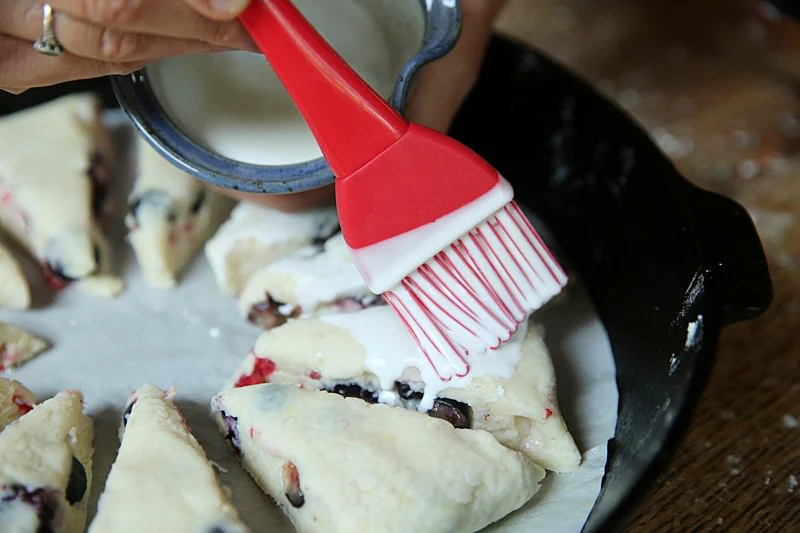 Image of Spread the cream over the scones with a brush of...