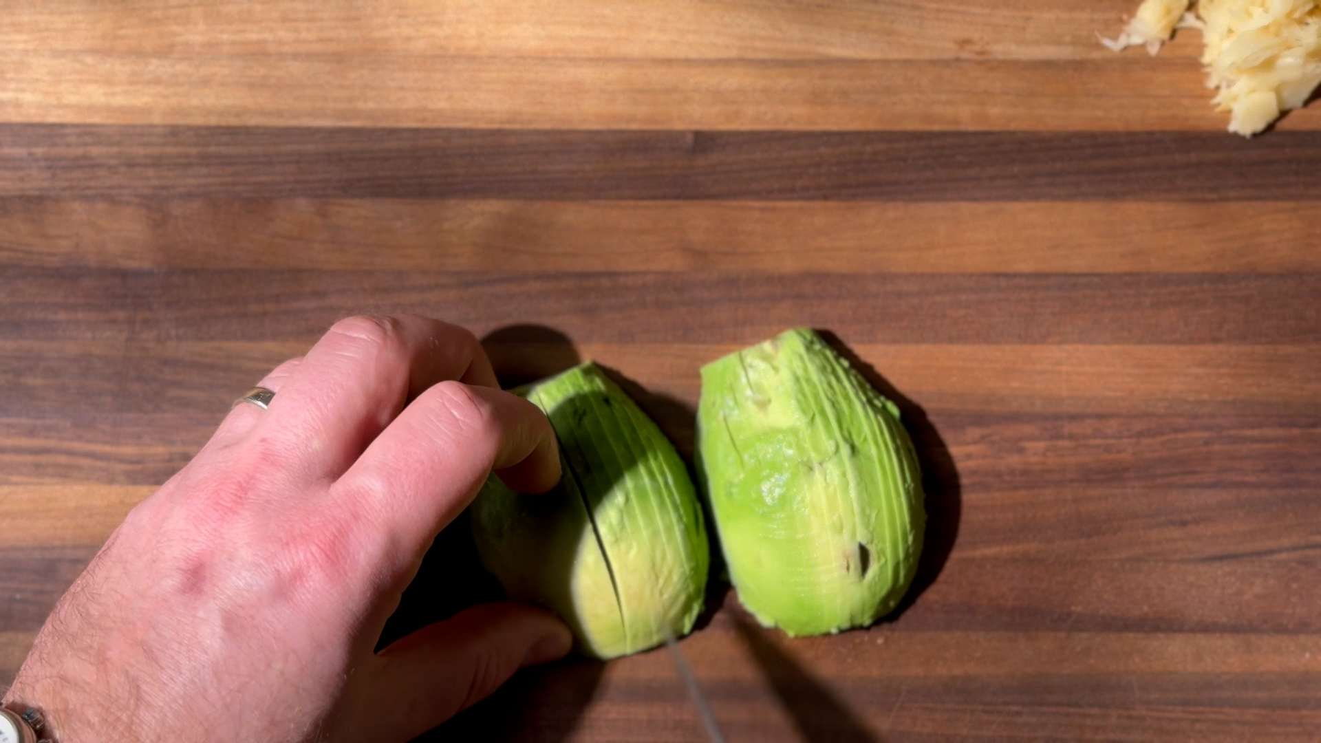 Image of Slice the Avocado: Cut the avocado into thin, uniform slices.