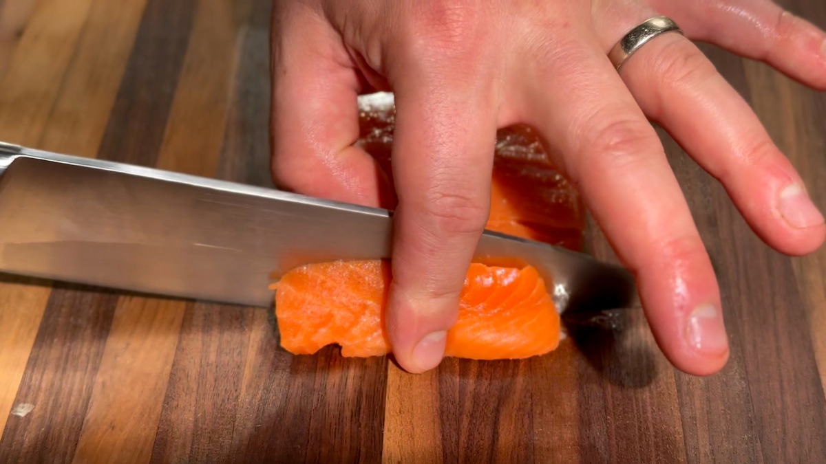 Image of Slice the Salmon: Cut the salmon into thick slices, removing...