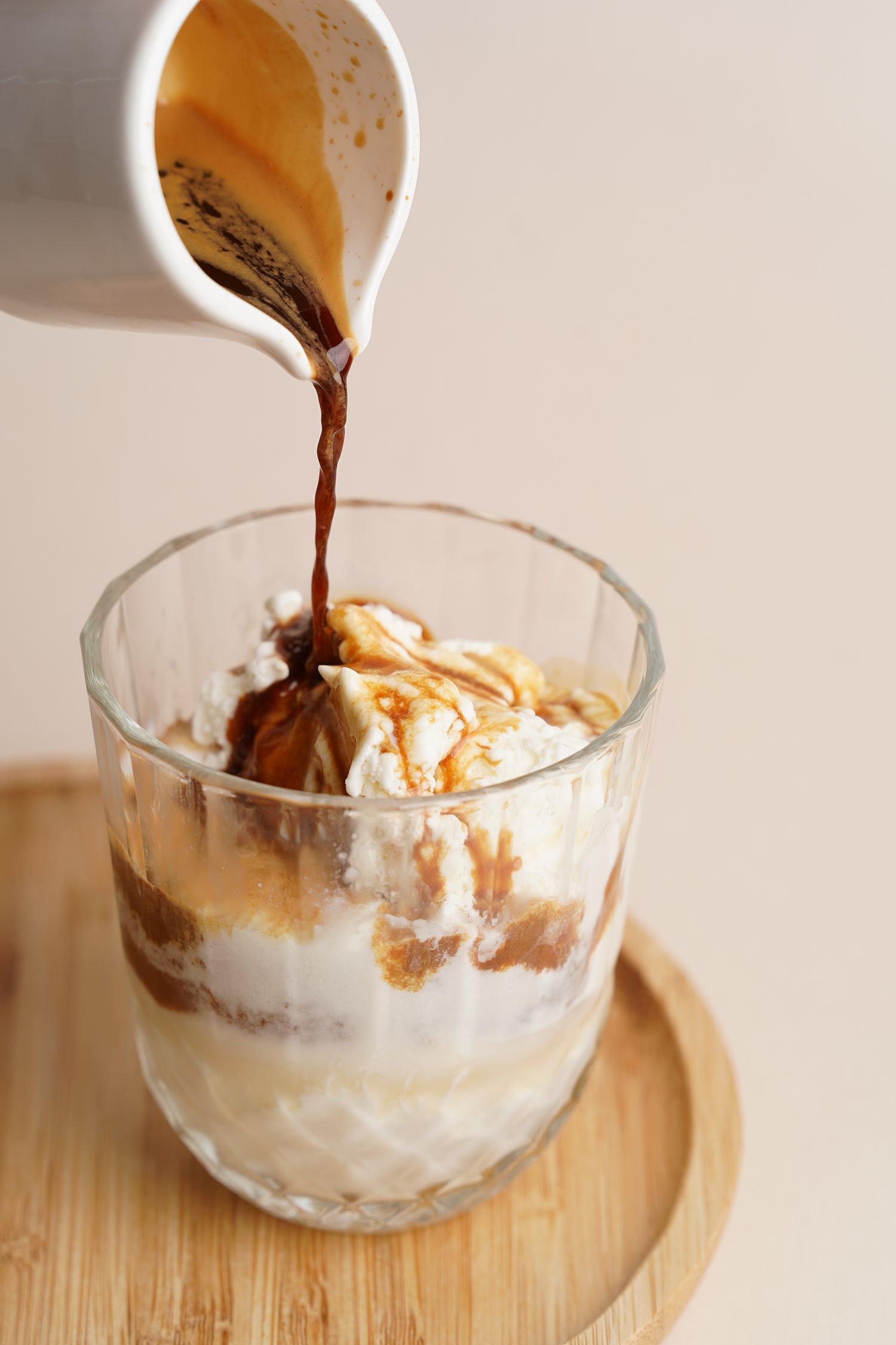 Image of Slowly pour num-spresso overtop the vanilla iced cream.