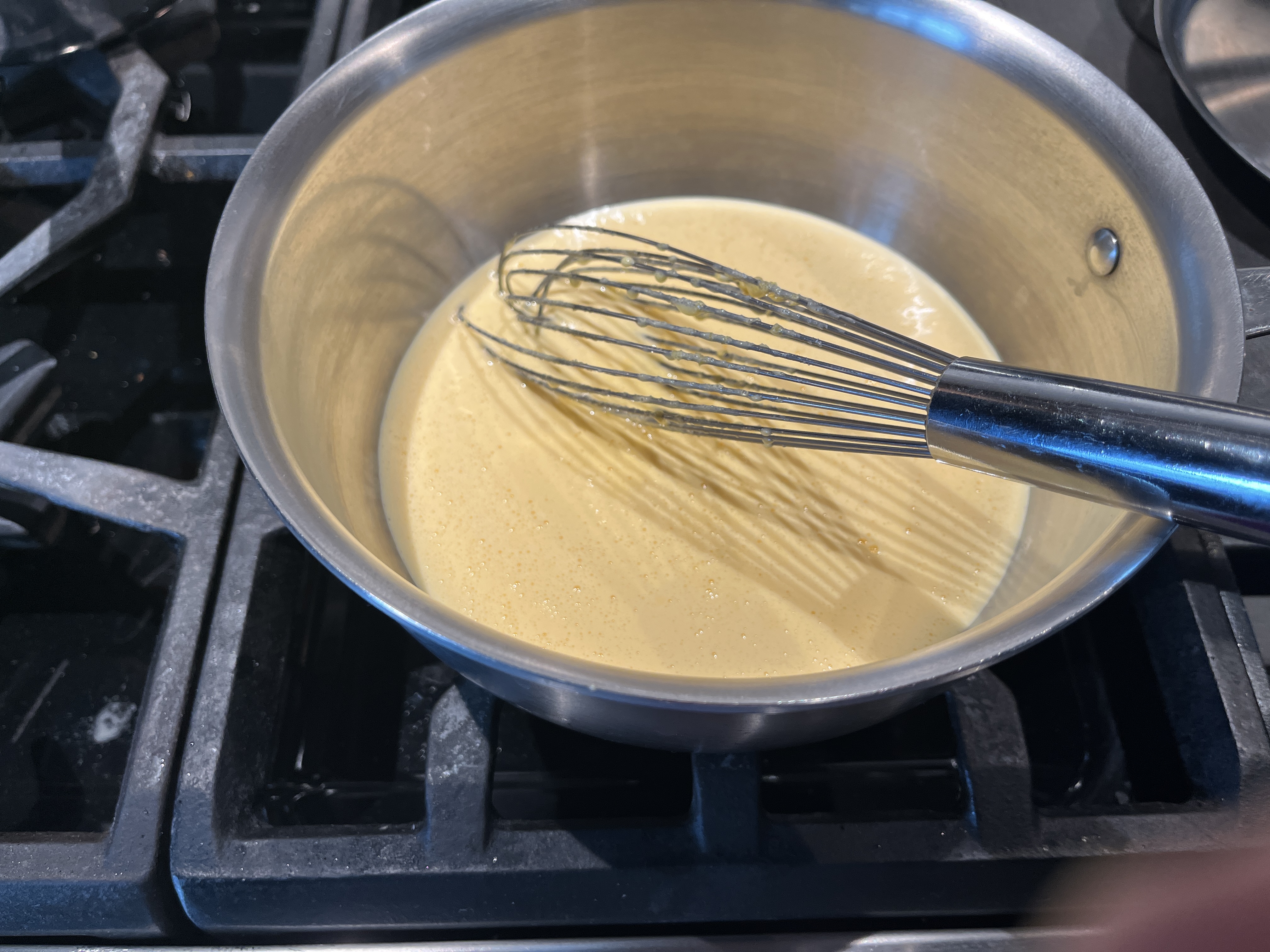 Image of Add the whisked yolk/sugar/lemon juice mixture into a heavy bottomed...