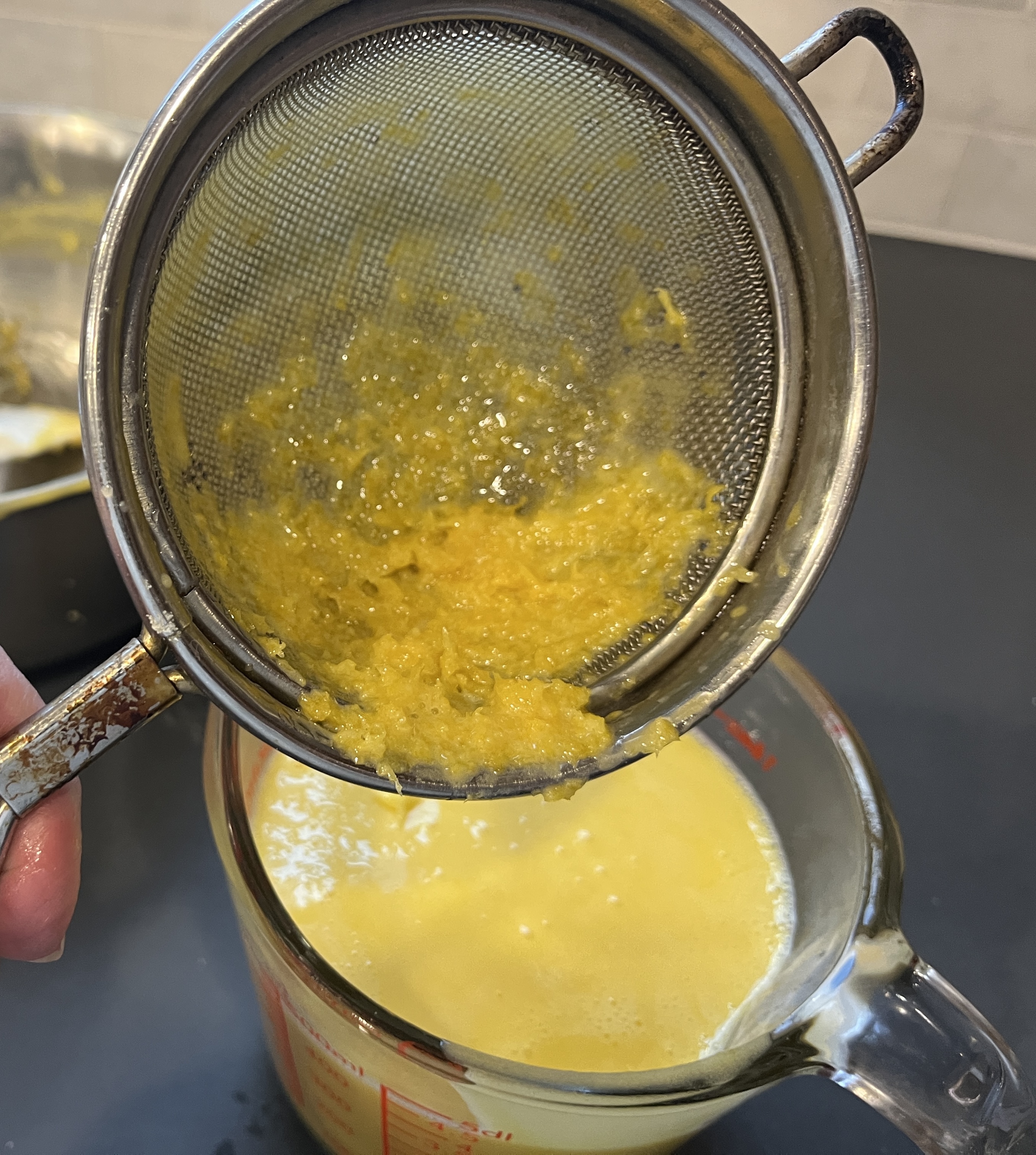 Image of Strain this mixture to remove the lemon zest. This will...