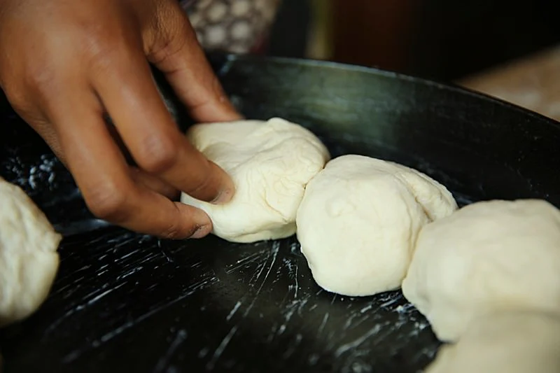 Image of Place each ball side by side in a buttered cast-iron...