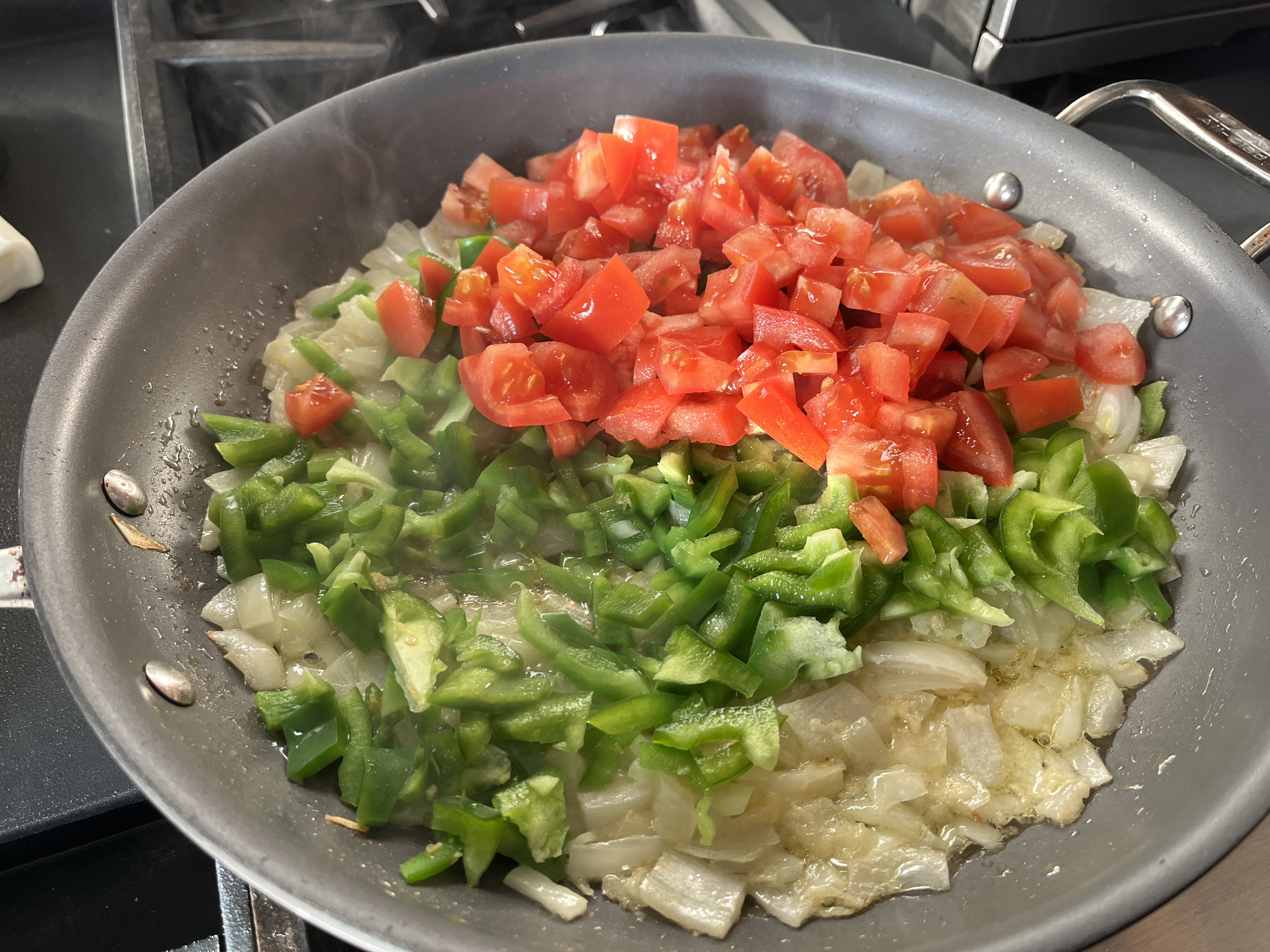 Image of To the onion, add bell pepper, chopped tomato, green chili...