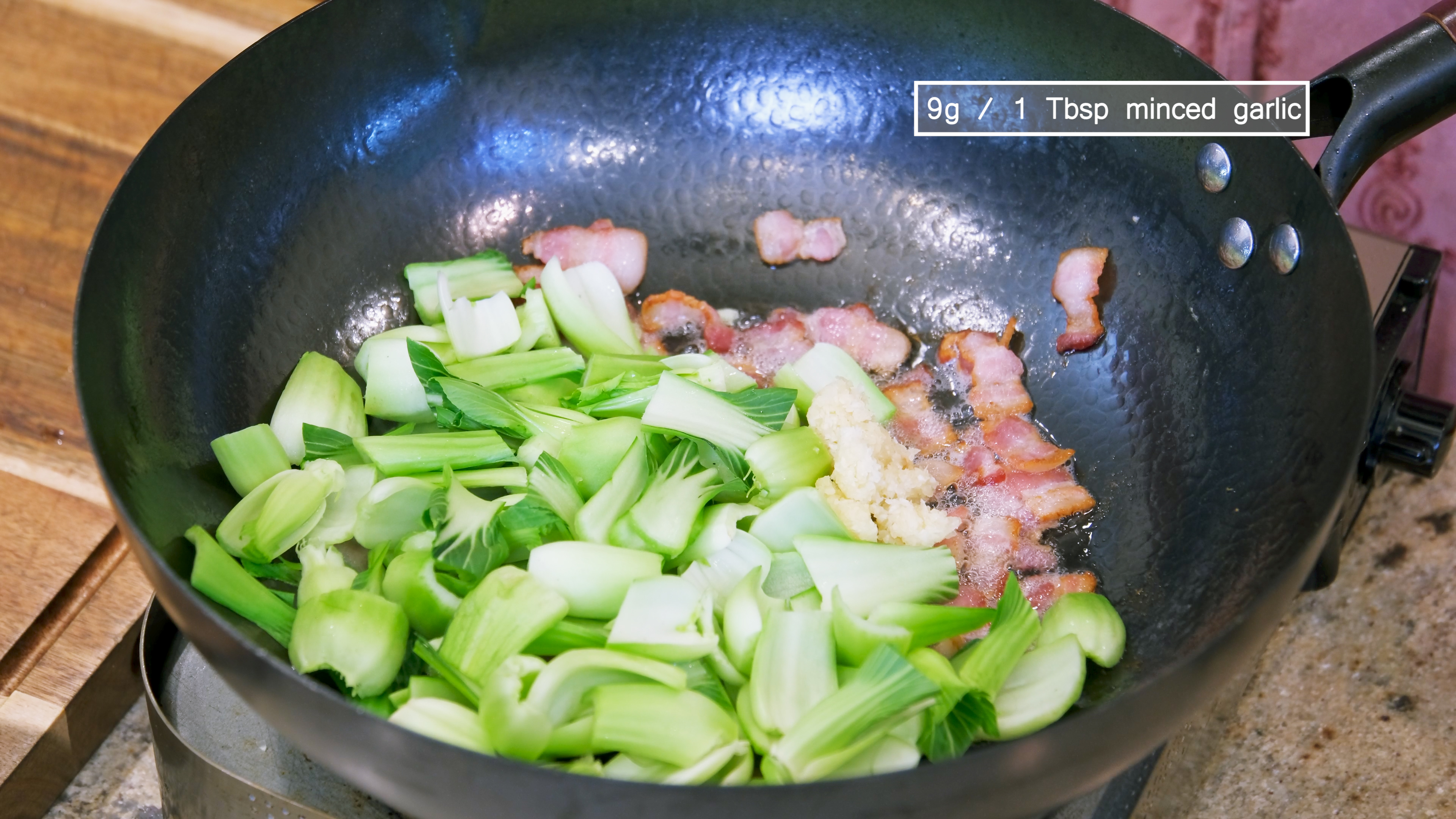 Image of Add the bok choy stems and 1 Tbsp of minced...