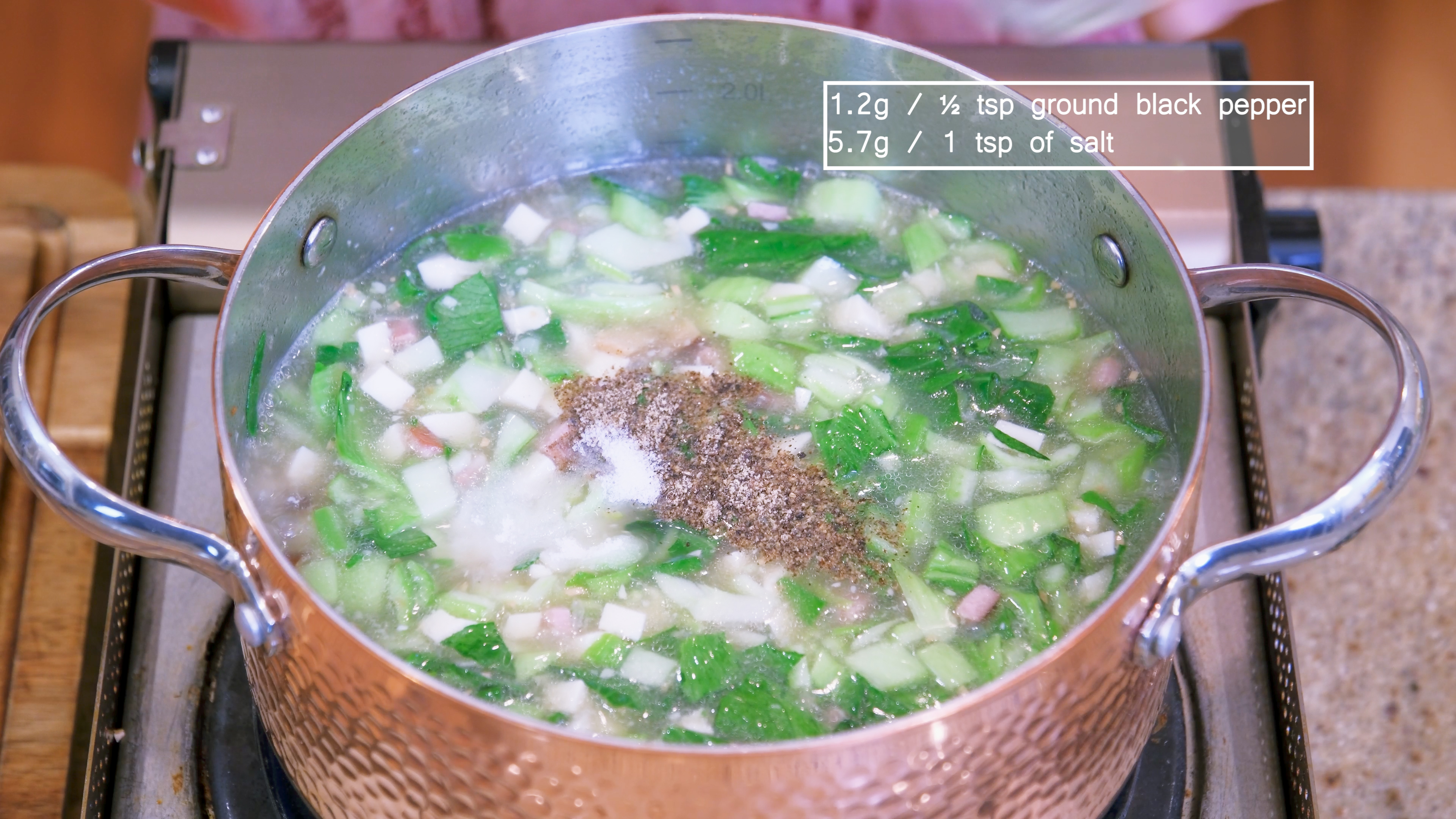 Image of Season the soup with ground black pepper and salt to...