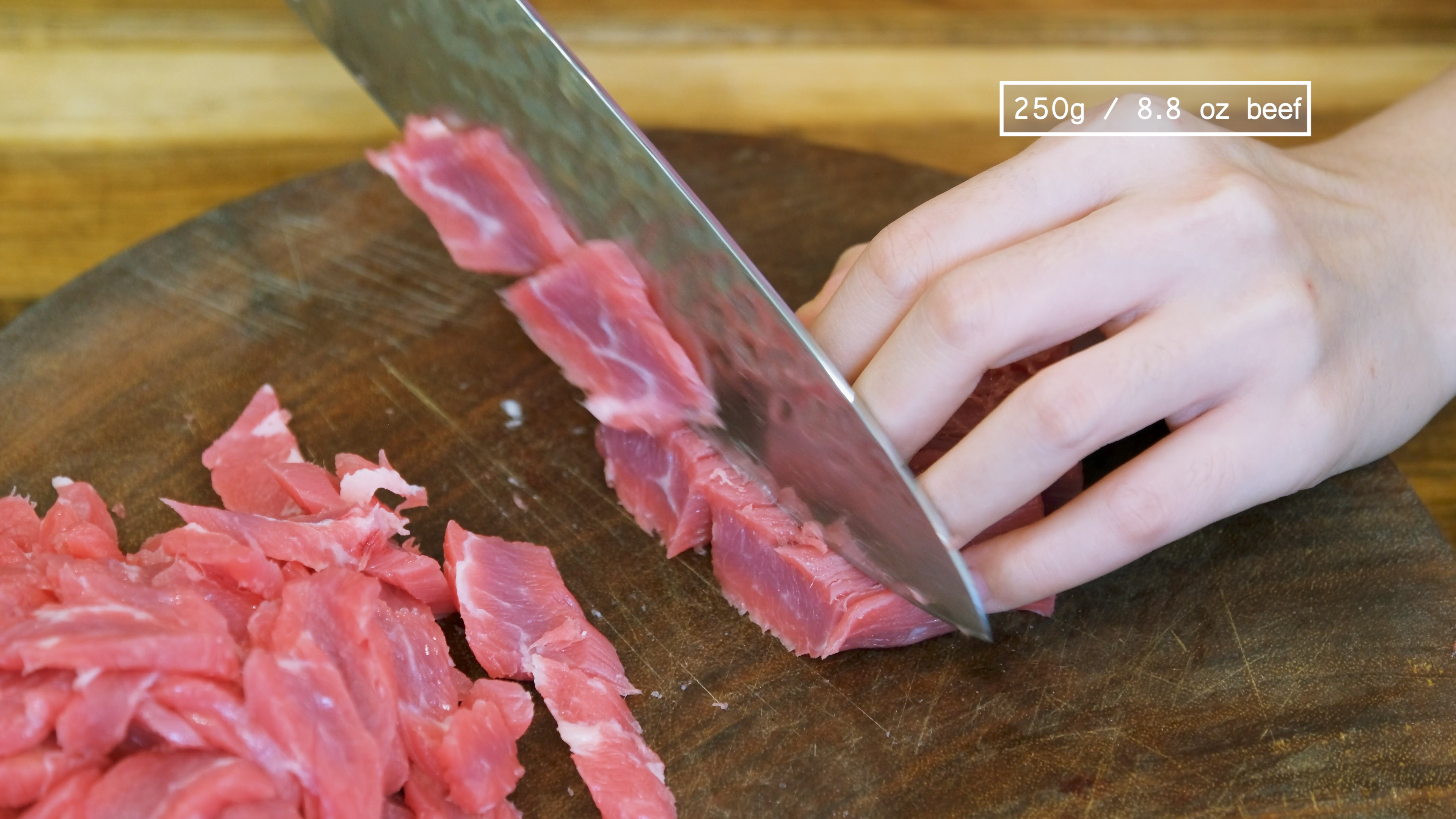 Image of Slice the beef into strips. Then, cut the strips into...