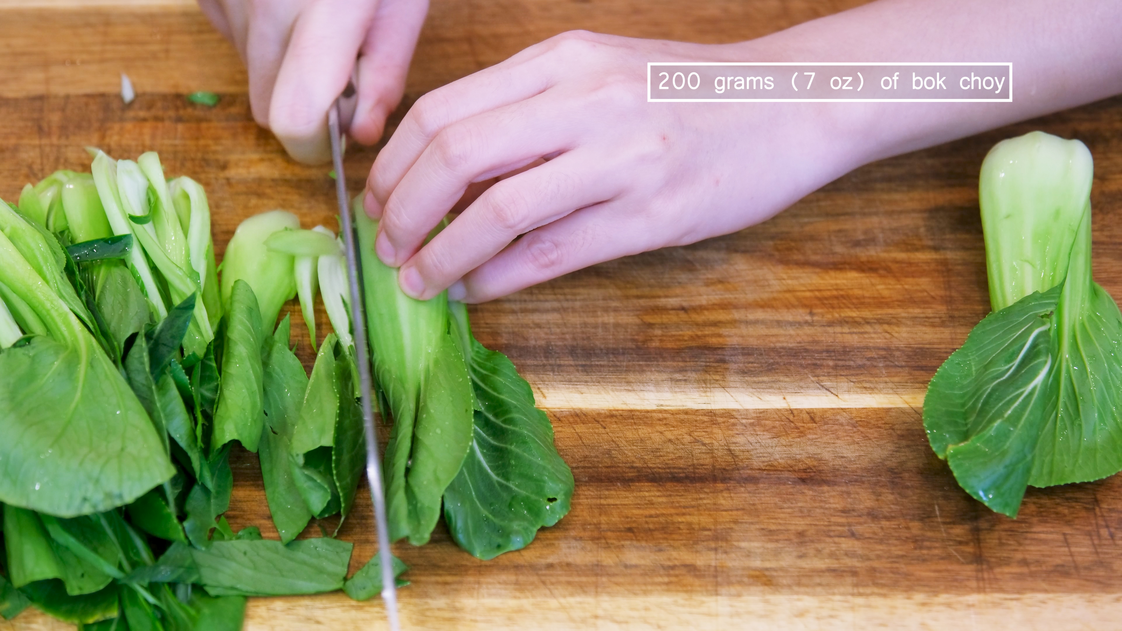 Image of While waiting, wash the bok choy and thinly julienne them...