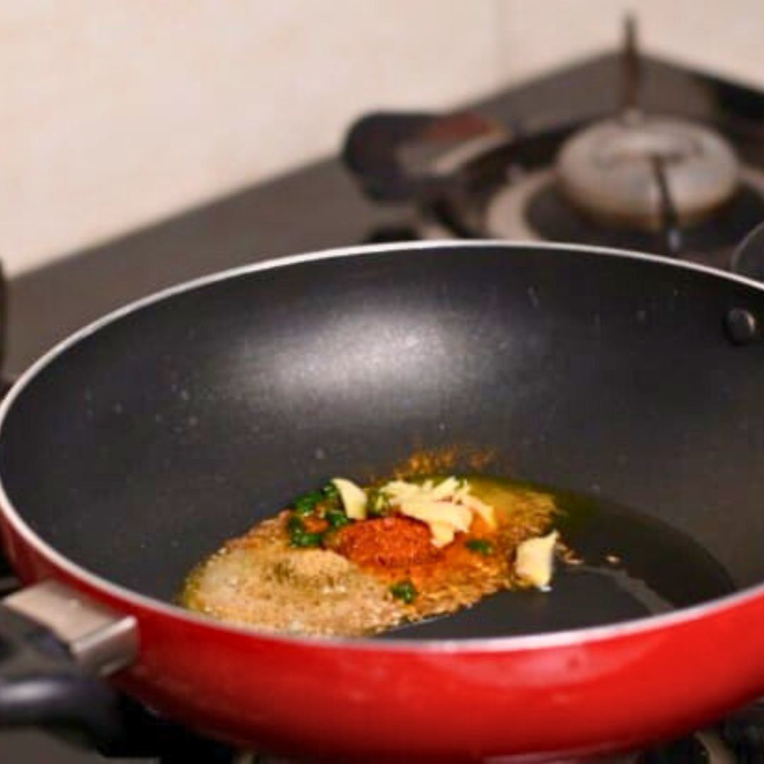 Image of Stir in asafoetida, grated ginger, turmeric powder, red chili powder,...