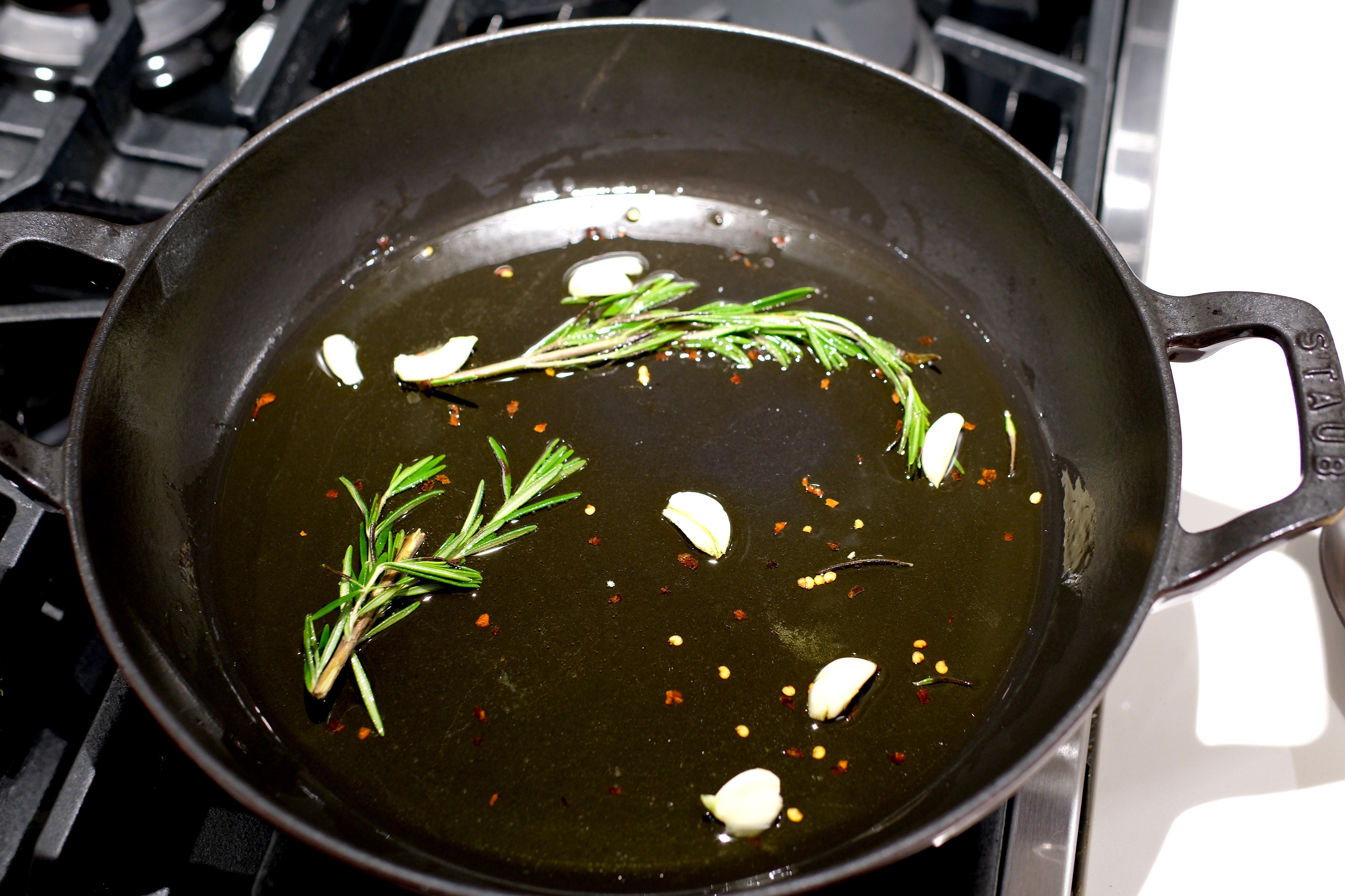 Image of Add olive oil, rosemary spring, red pepper and crushed garlic...