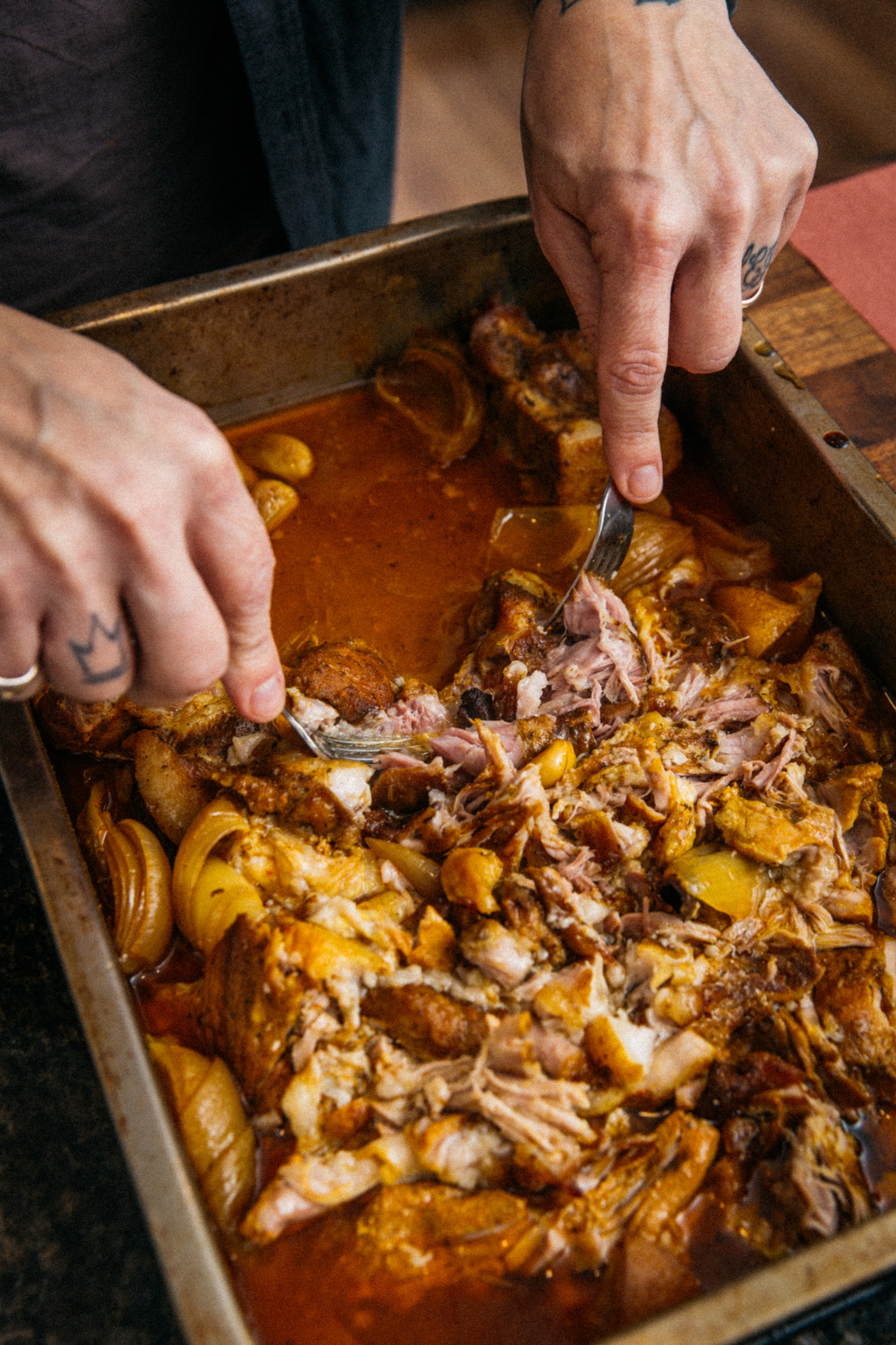 Image of Shred pork pieces to desired texture/size.