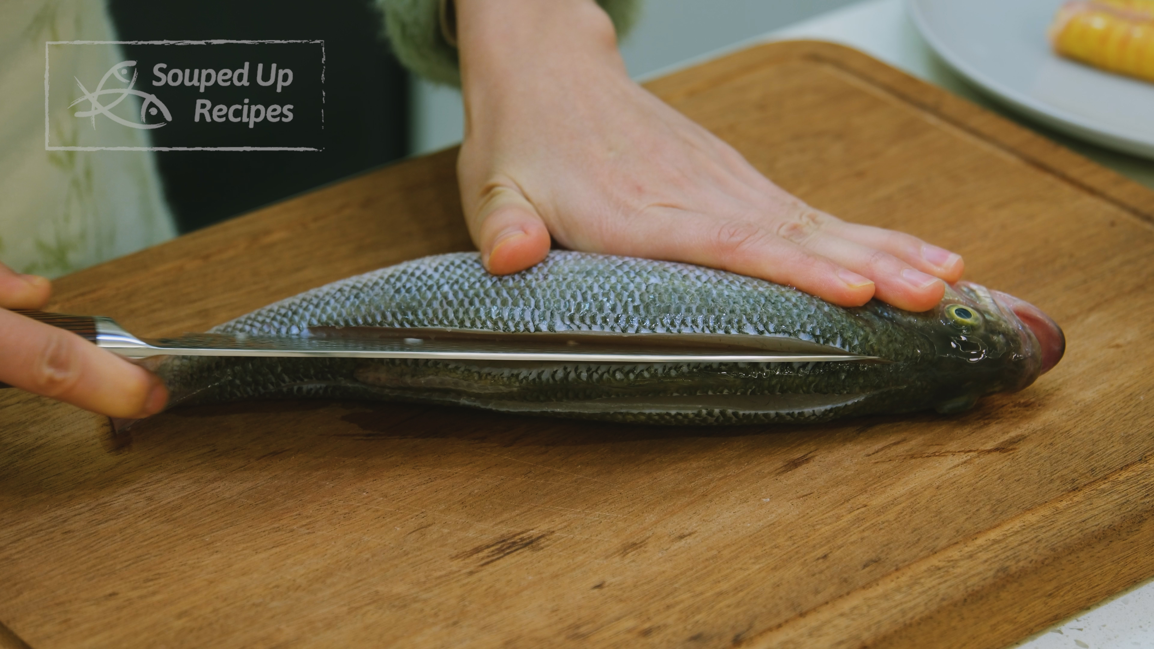 Image of Use a sharp knife to score the fish flesh along...