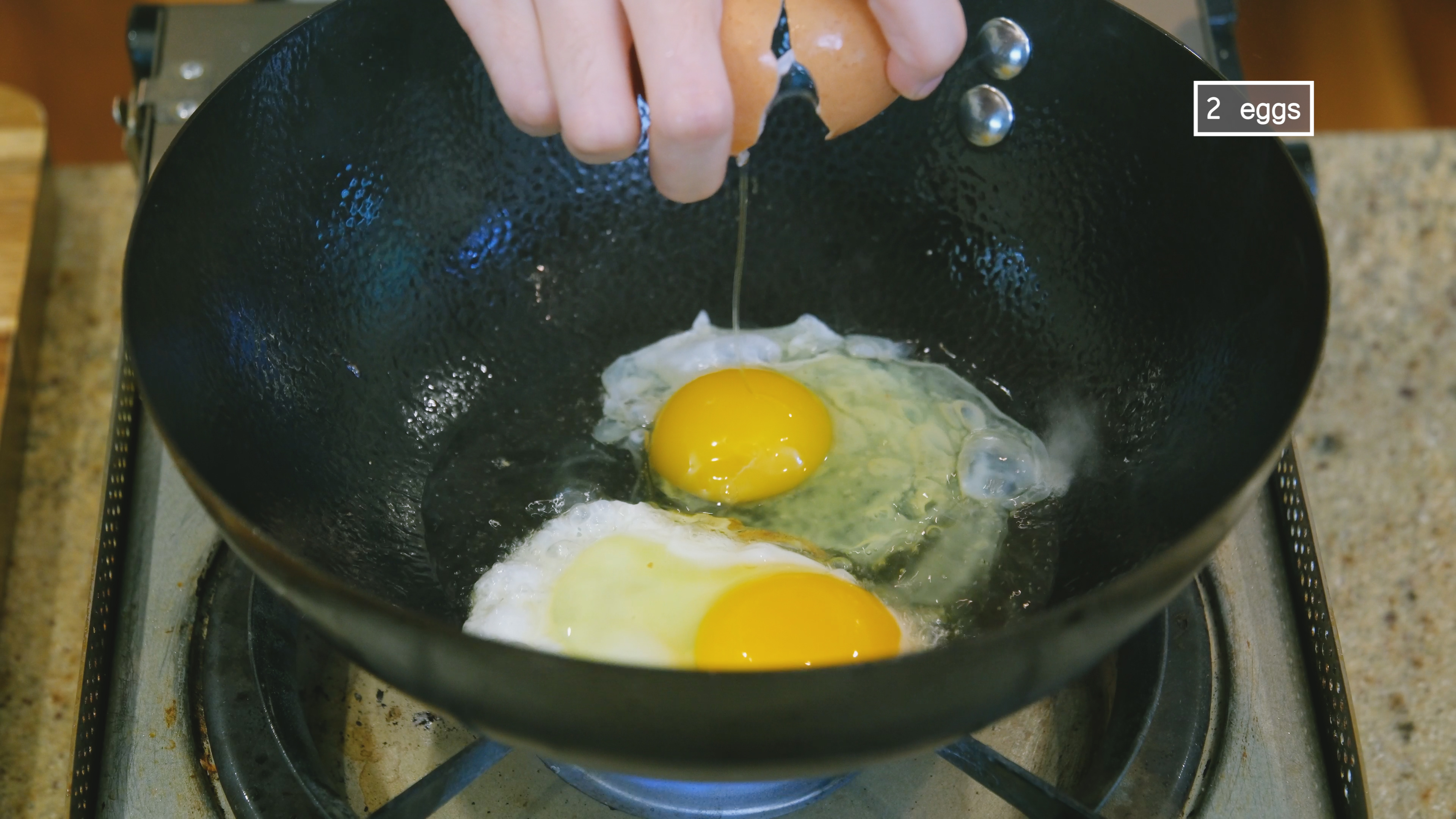 Image of To the same wok, crack in 2 eggs and pan...