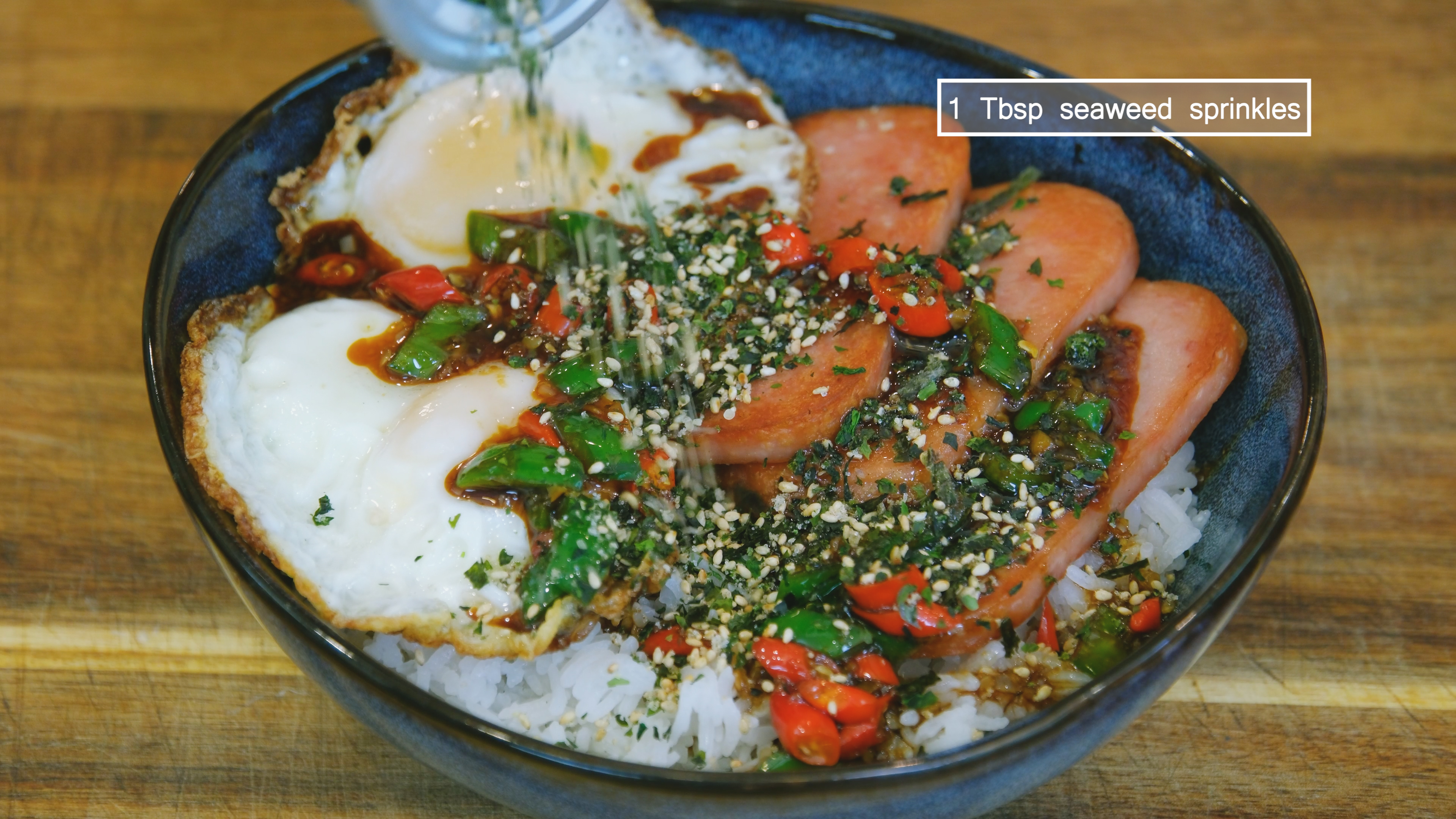 Image of Place the egg onto the rice and drizzle the sauce...