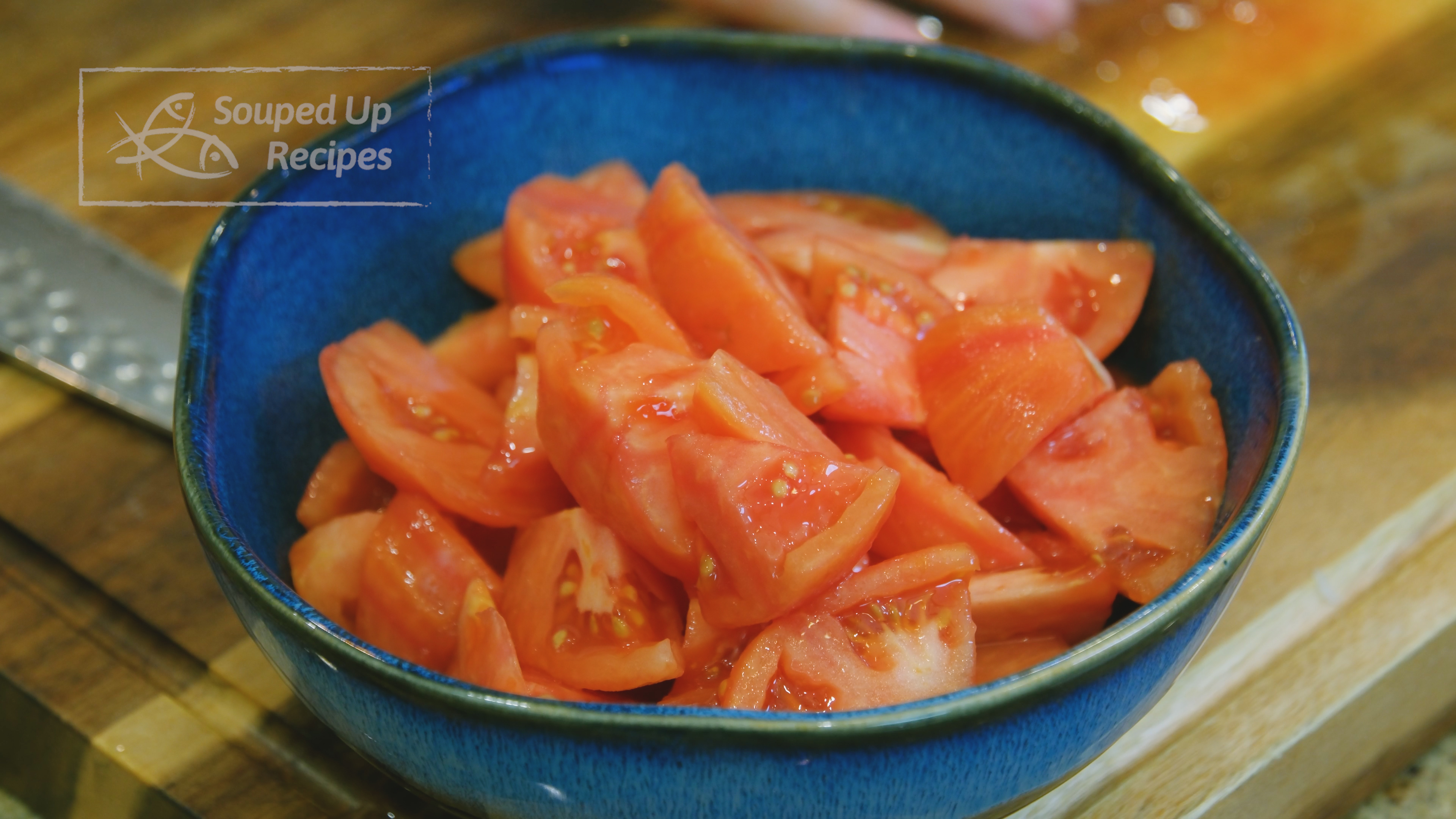 Image of Once cooled, peel the tomato skin and cut the tomatoes...