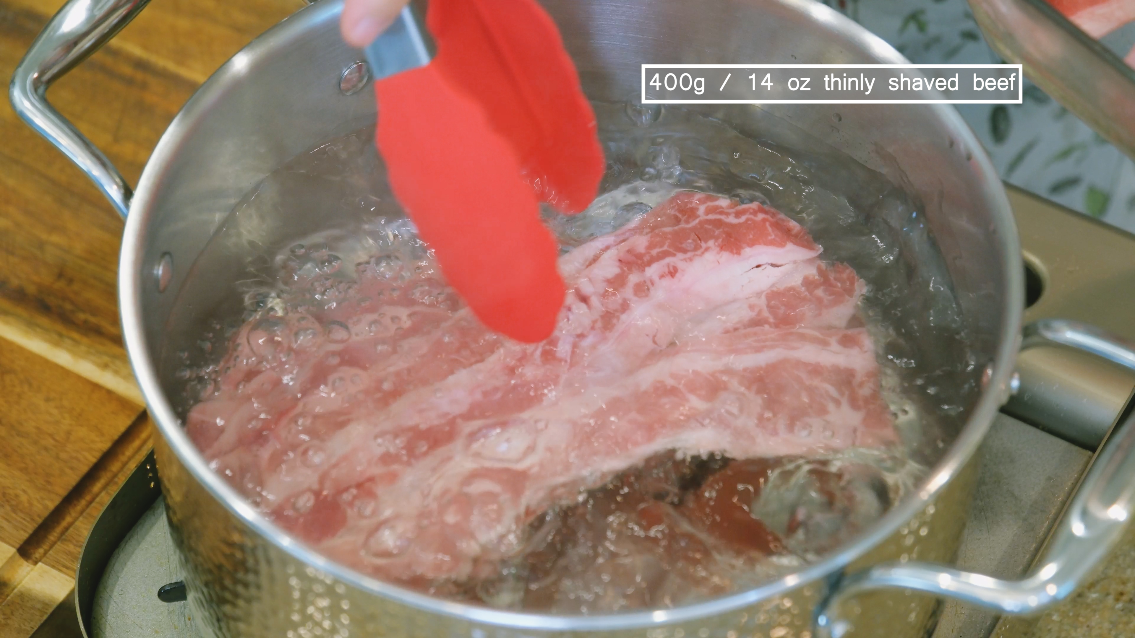 Image of Add the thinly shaved beef to the boiling water and...