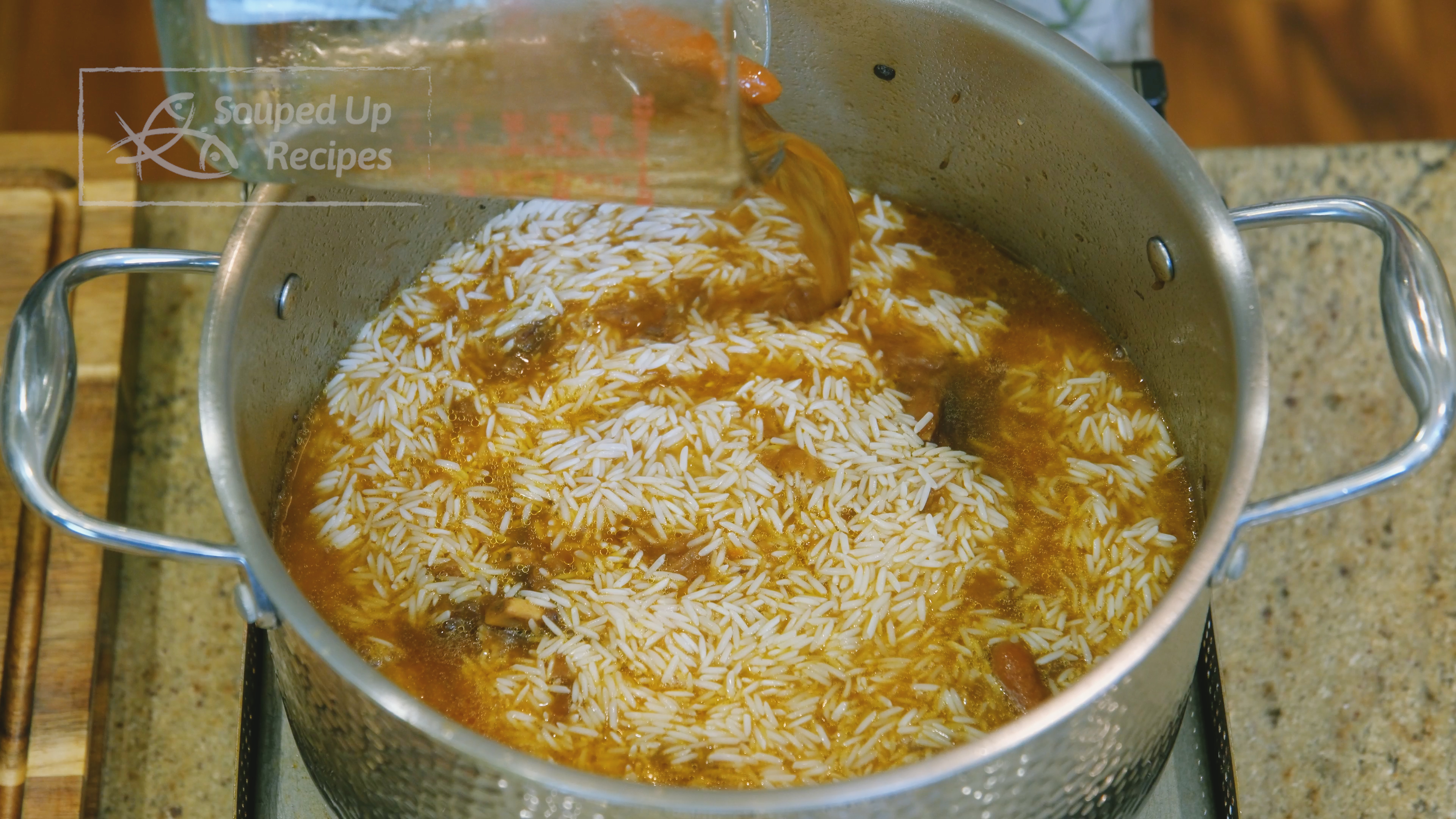 Image of Pour the broth back into the pot. Drain the rice...