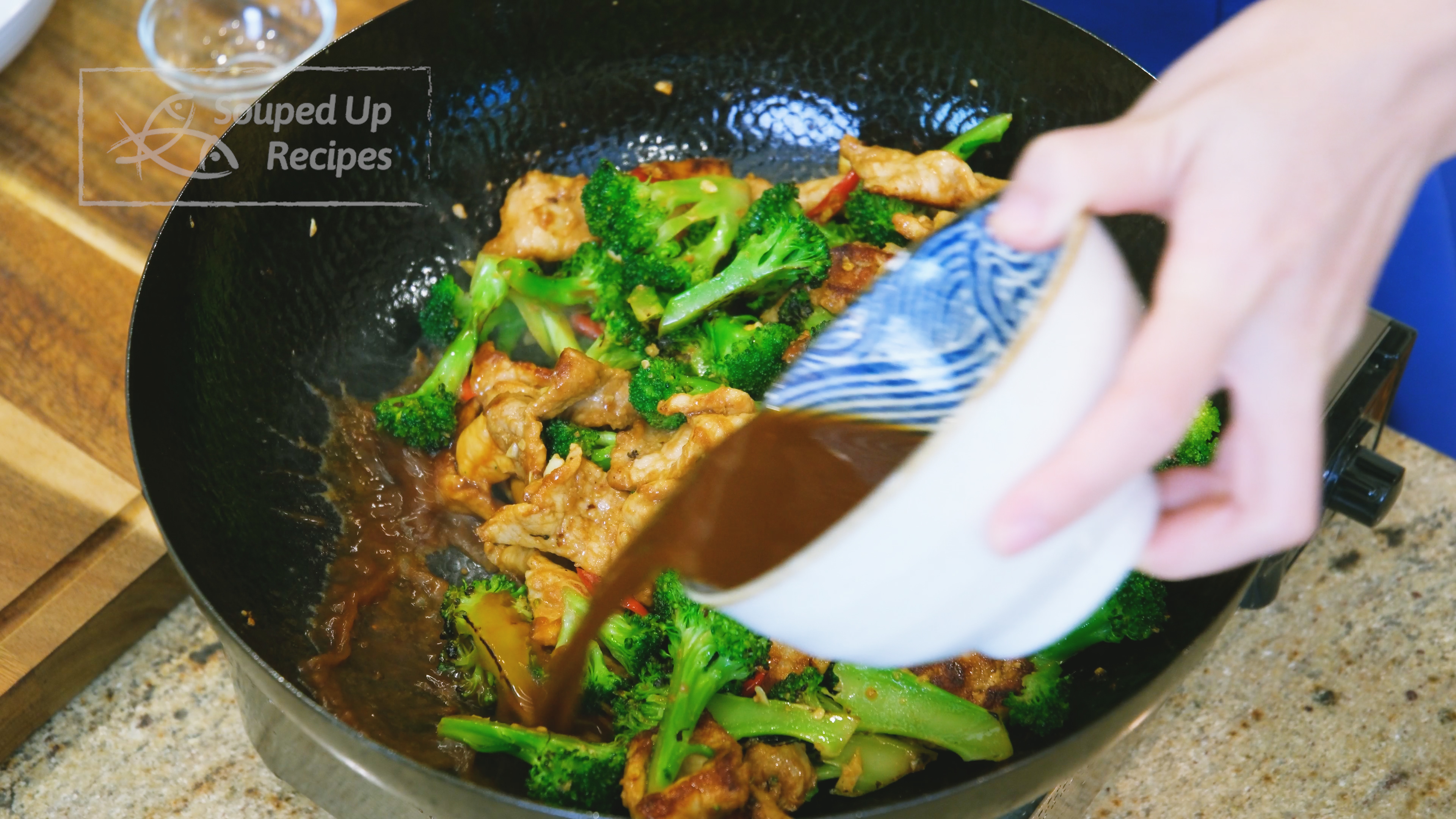 Image of Introduce the broccoli back into the wok. Pour in the...