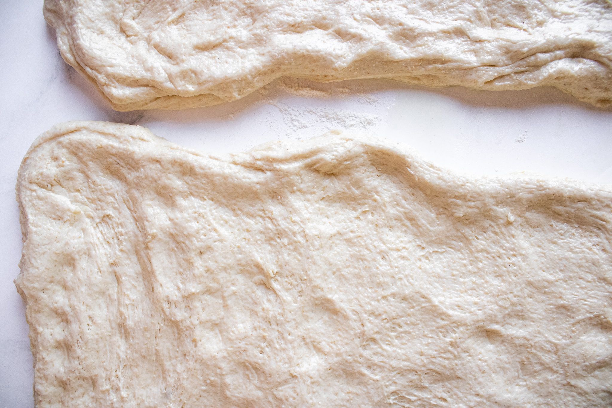 Image of Cut dough in ½ and spread into rectangle shape 