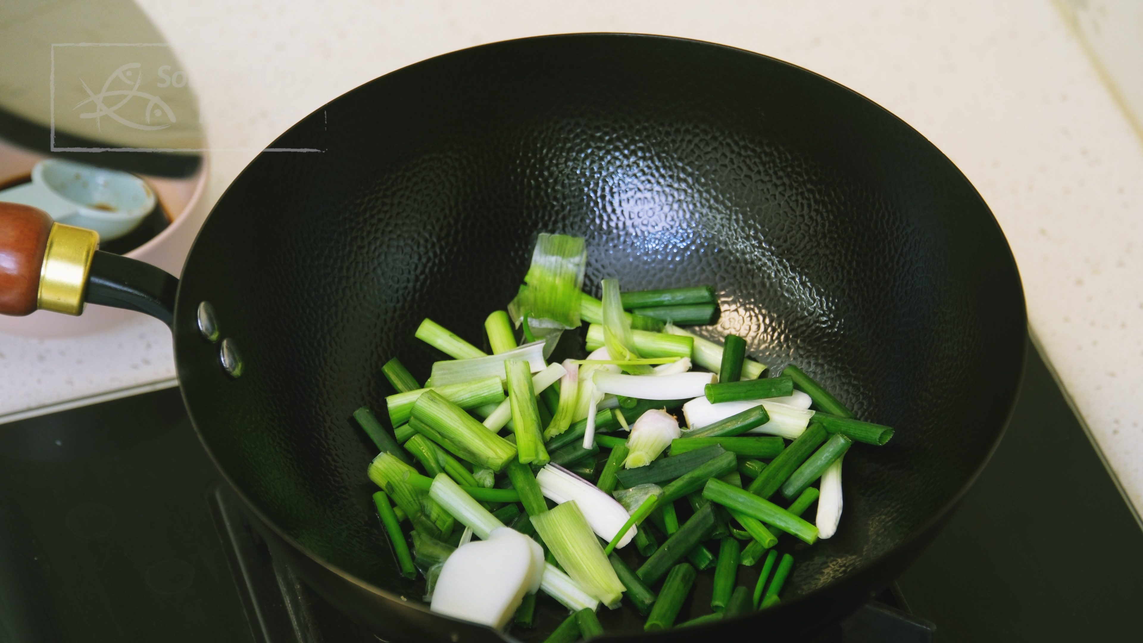 Image of Cut the bottom parts of the scallions into 2-inch-long pieces...