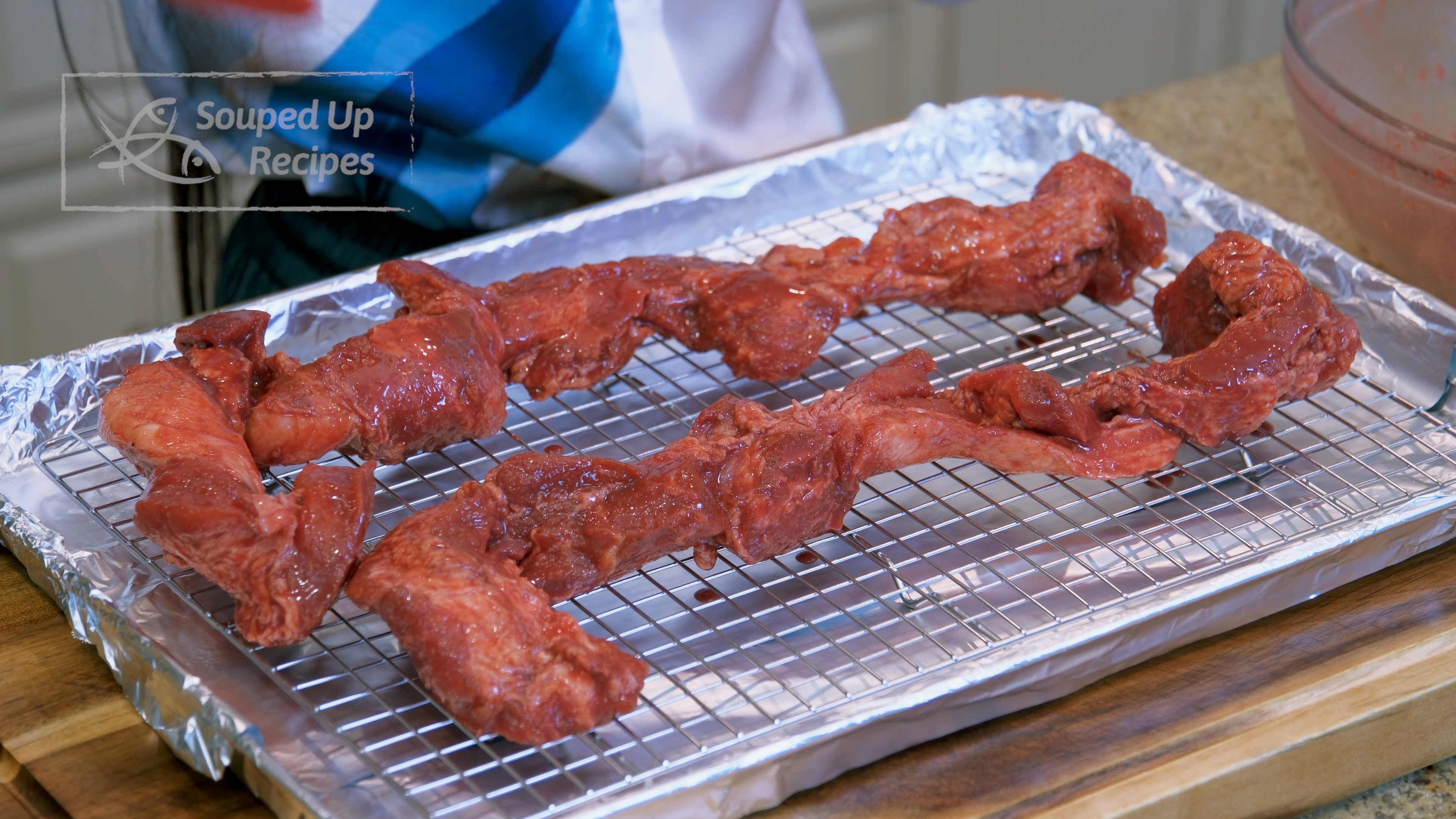 Image of Wrap a baking pan with tinfoil. Put a baking rack...