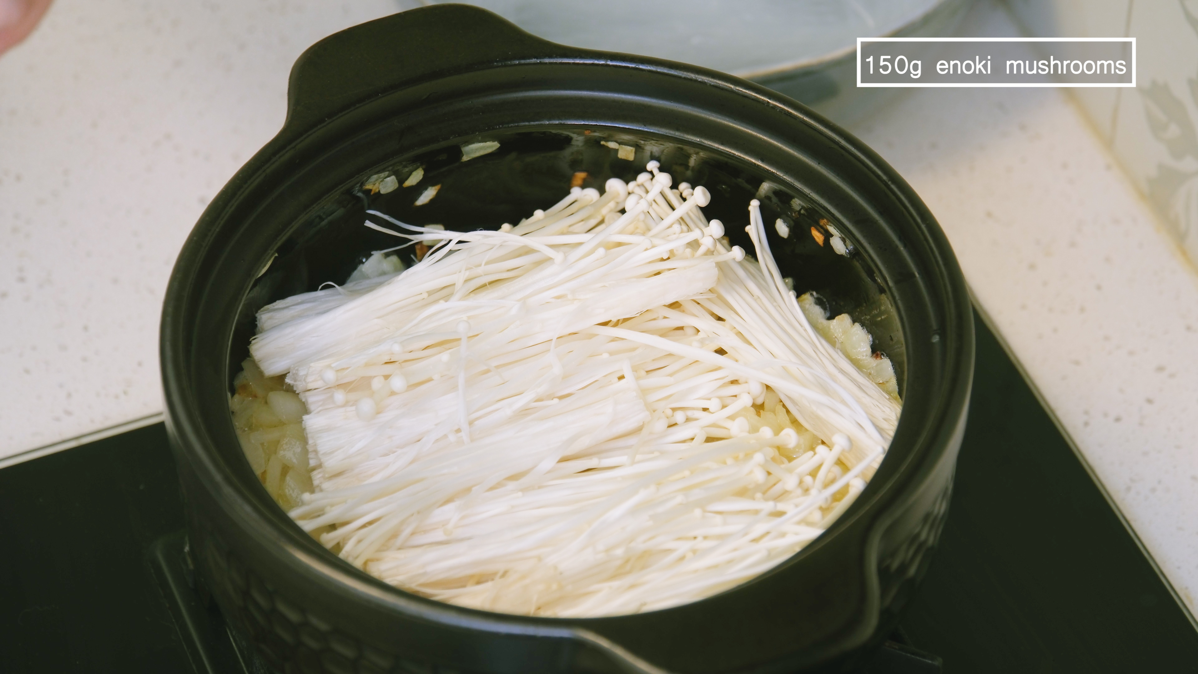 Image of Add the enoki mushrooms and spread them evenly on the...