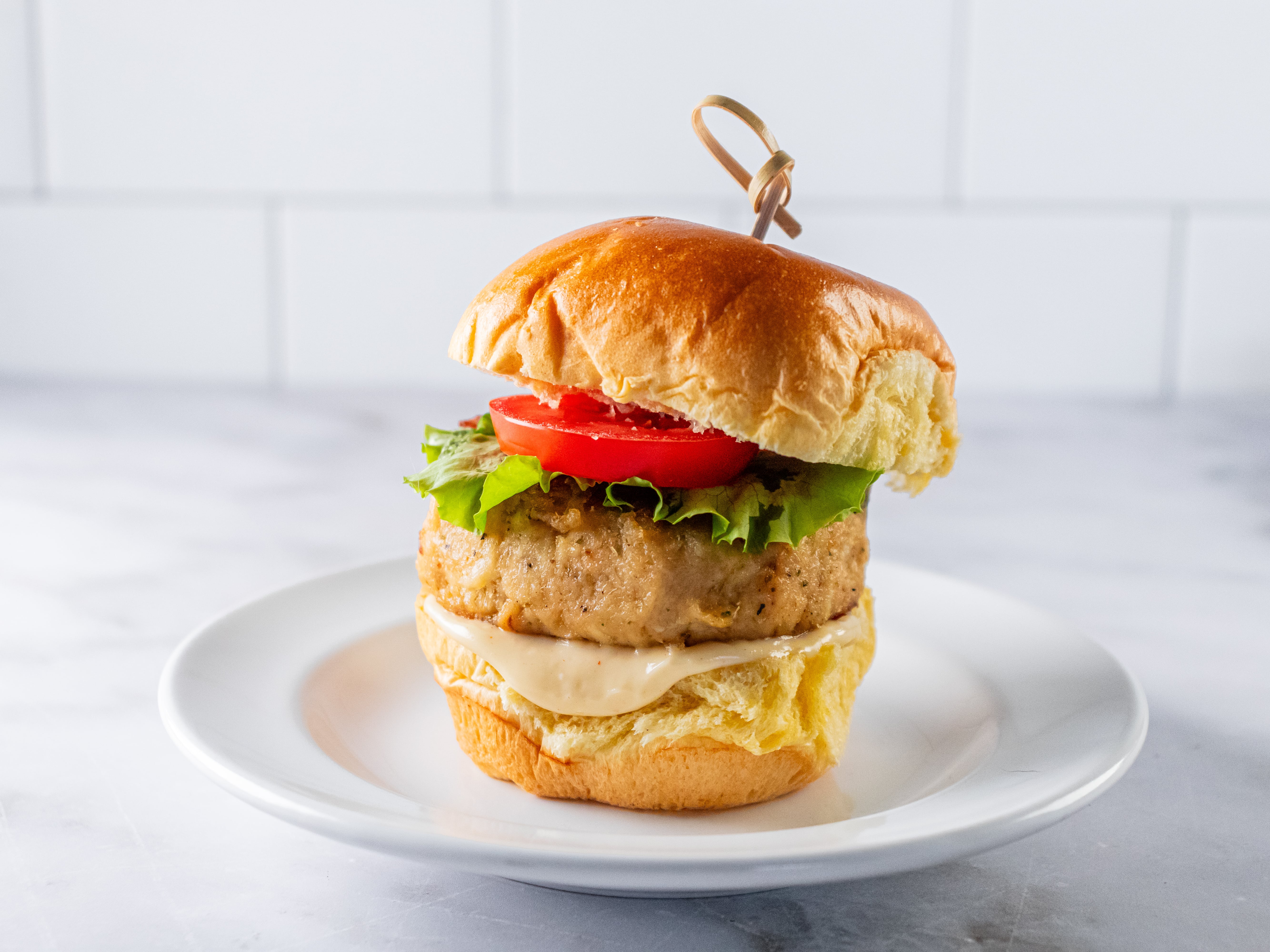Image of Spread remoulade on bottom buns. Place a crab cake on...